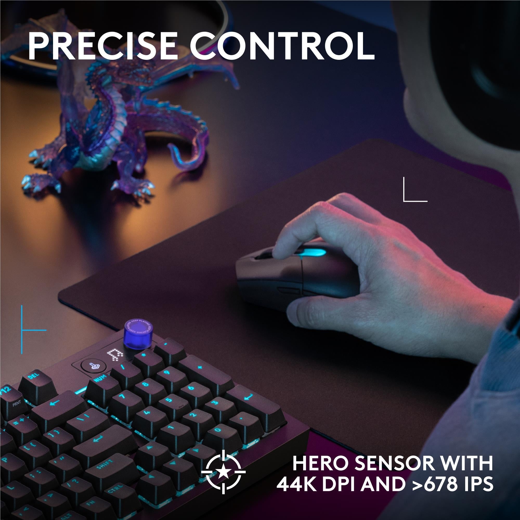 Black gaming mouse in use on a desk with illuminated keyboard and blue accent lighting.