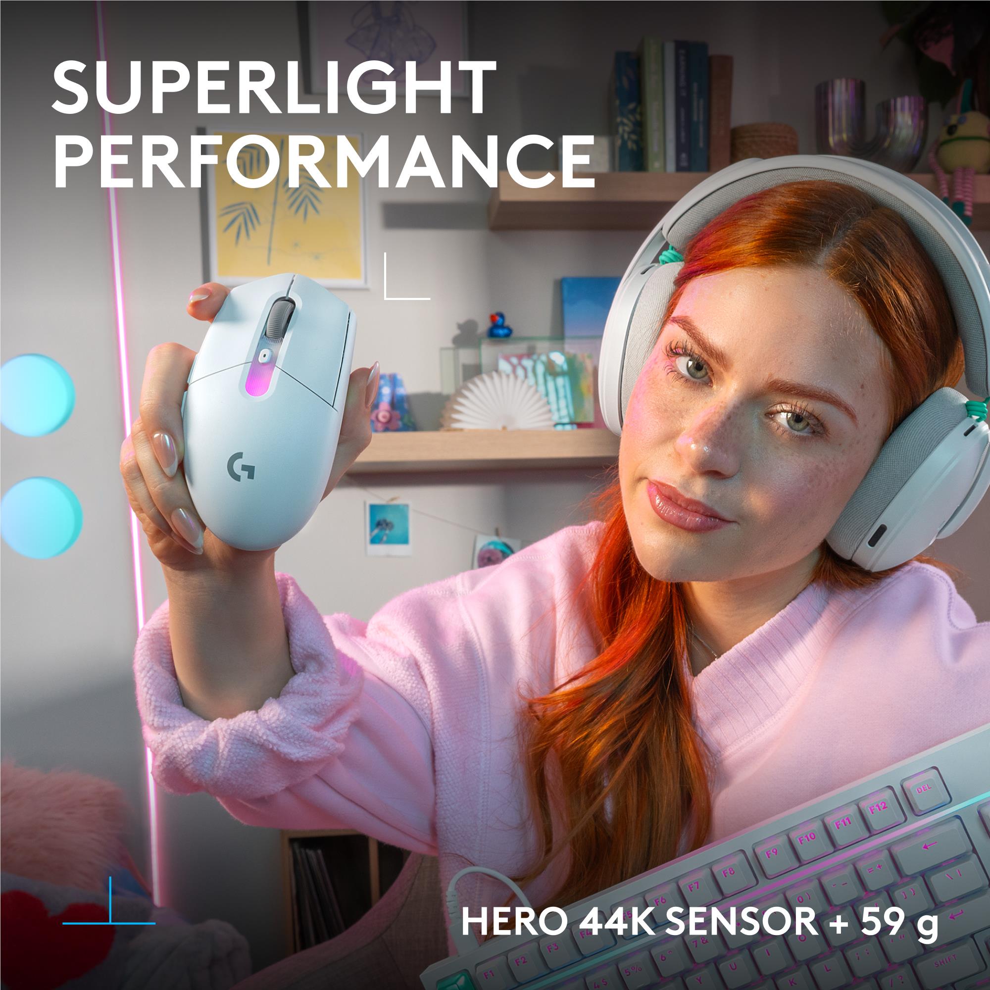 White wireless gaming mouse held in hand, blue light strip on top and side buttons.