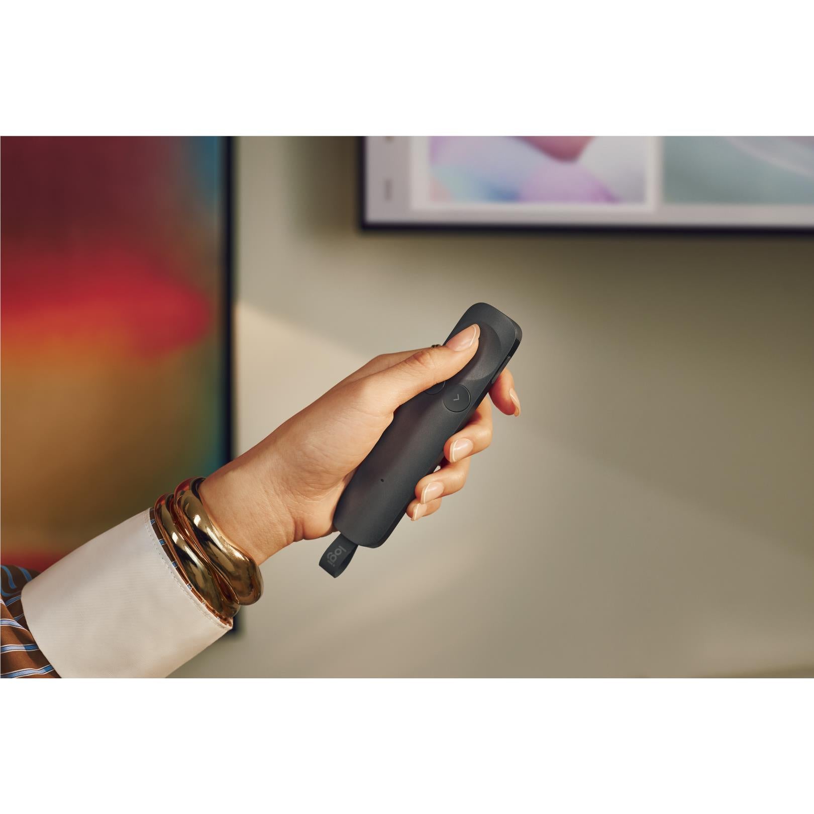 Graphite wireless presentation remote close-up from side, thumb and buttons visible