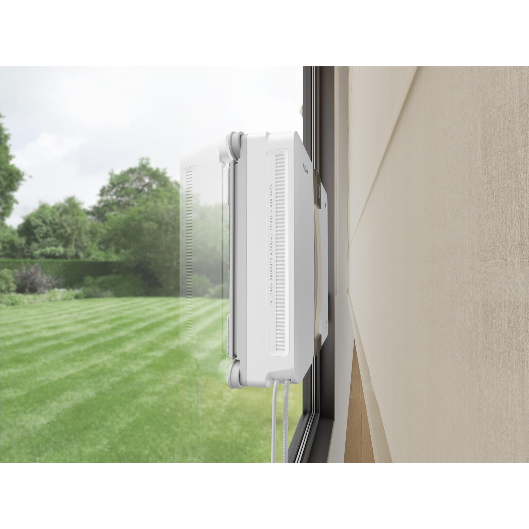 Window cleaning robot attached to window edge, side vents visible on white housing