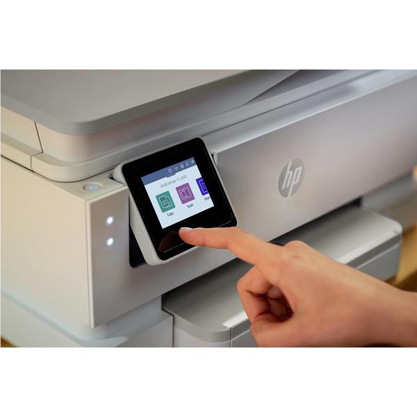 HP all-in-one printer with color touchscreen; finger touching the display