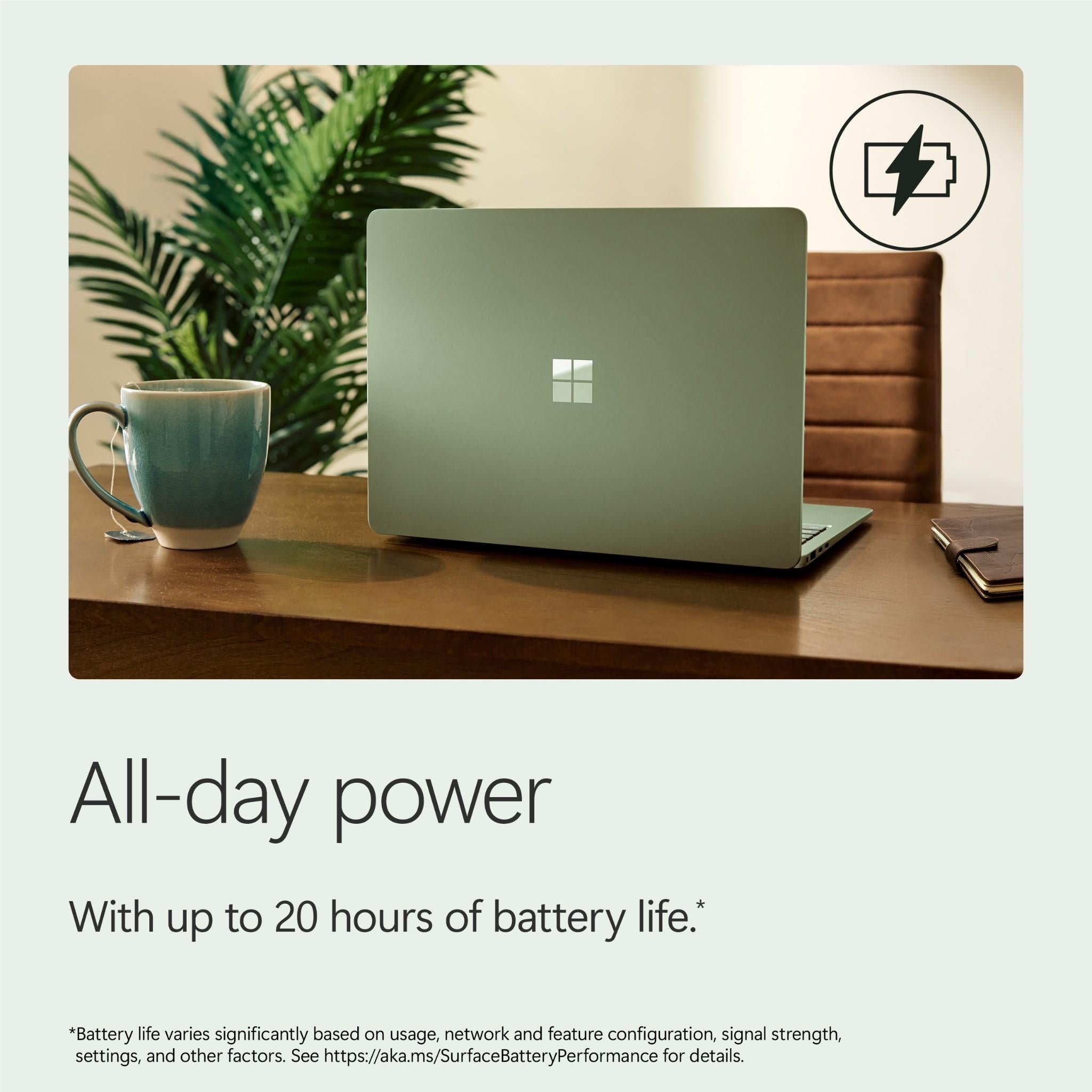Jade Surface Laptop on desk with mug and plant in the scene