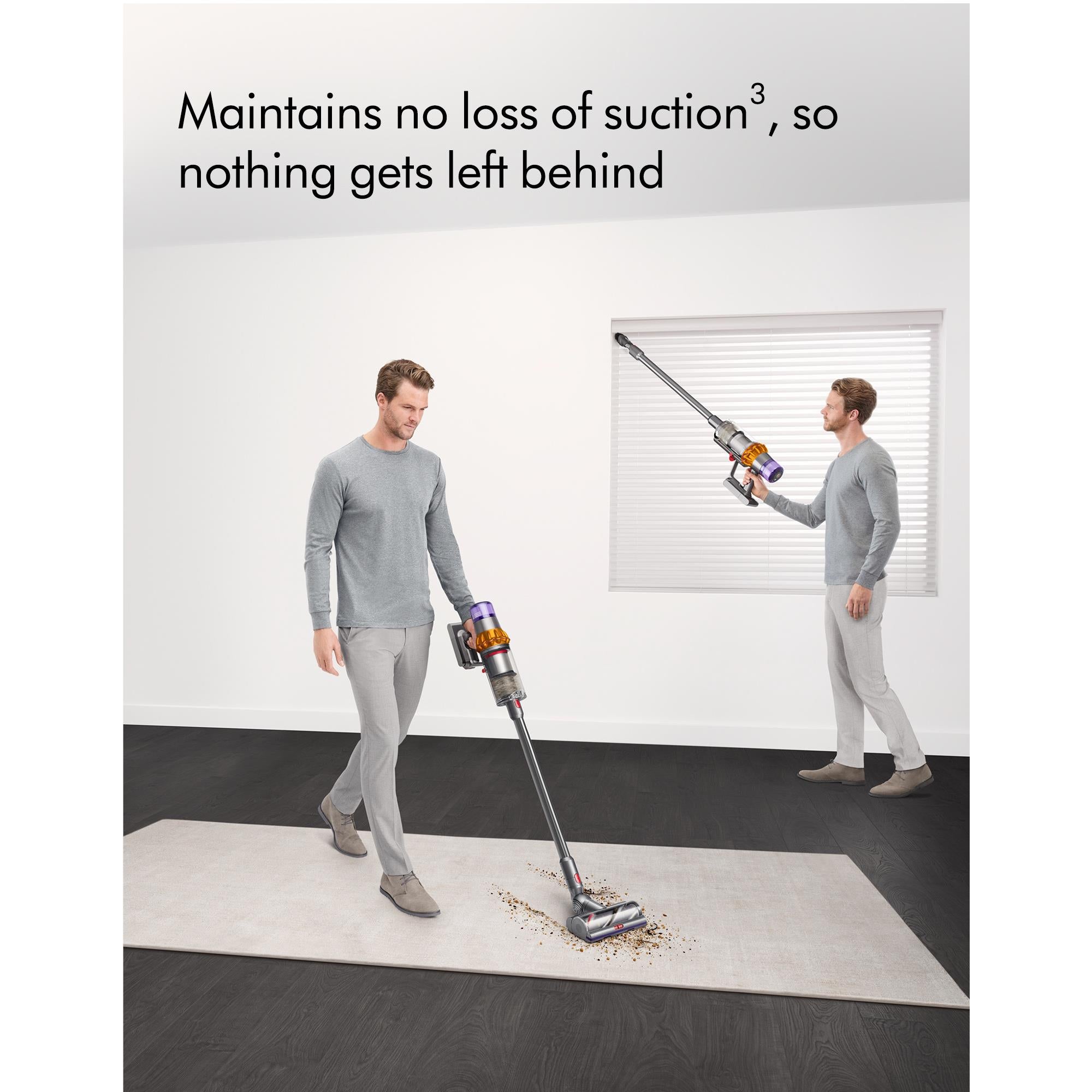 Dyson cordless stick vacuum in use with floor nozzle extended