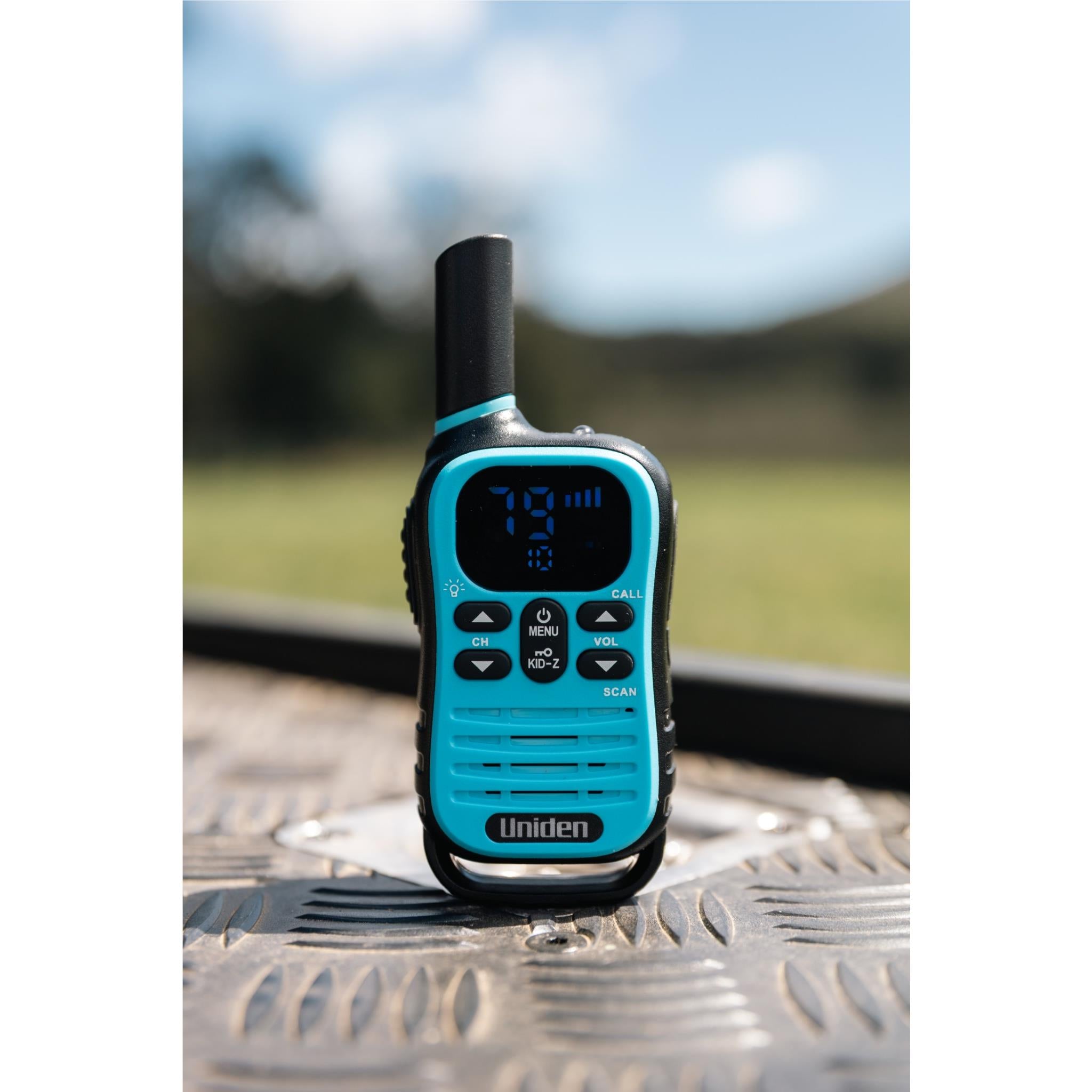 Uniden Kid-Zone Plus UHF radio, blue front on textured metal surface
