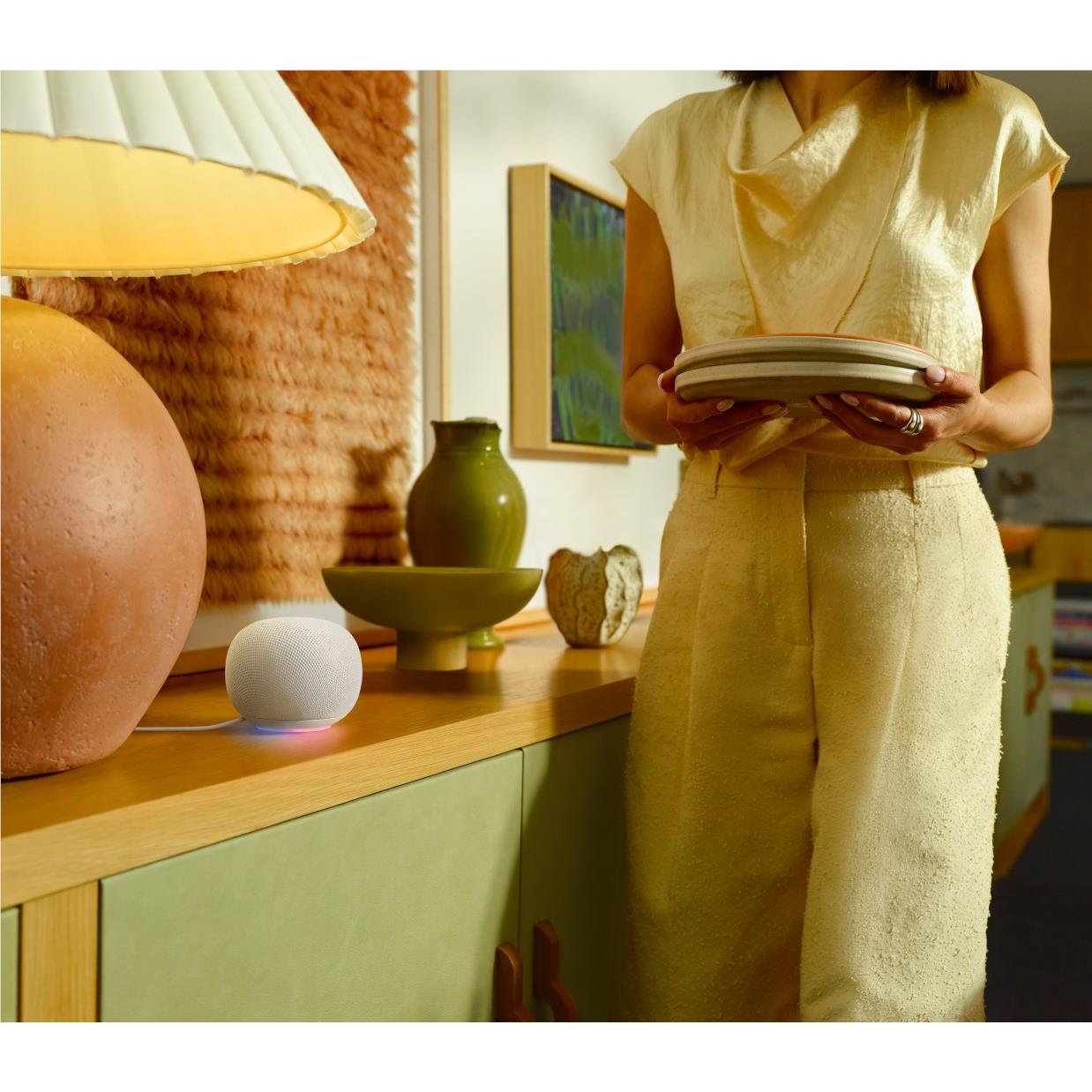 Google Home smart speaker, porcelain white puck on kitchen counter