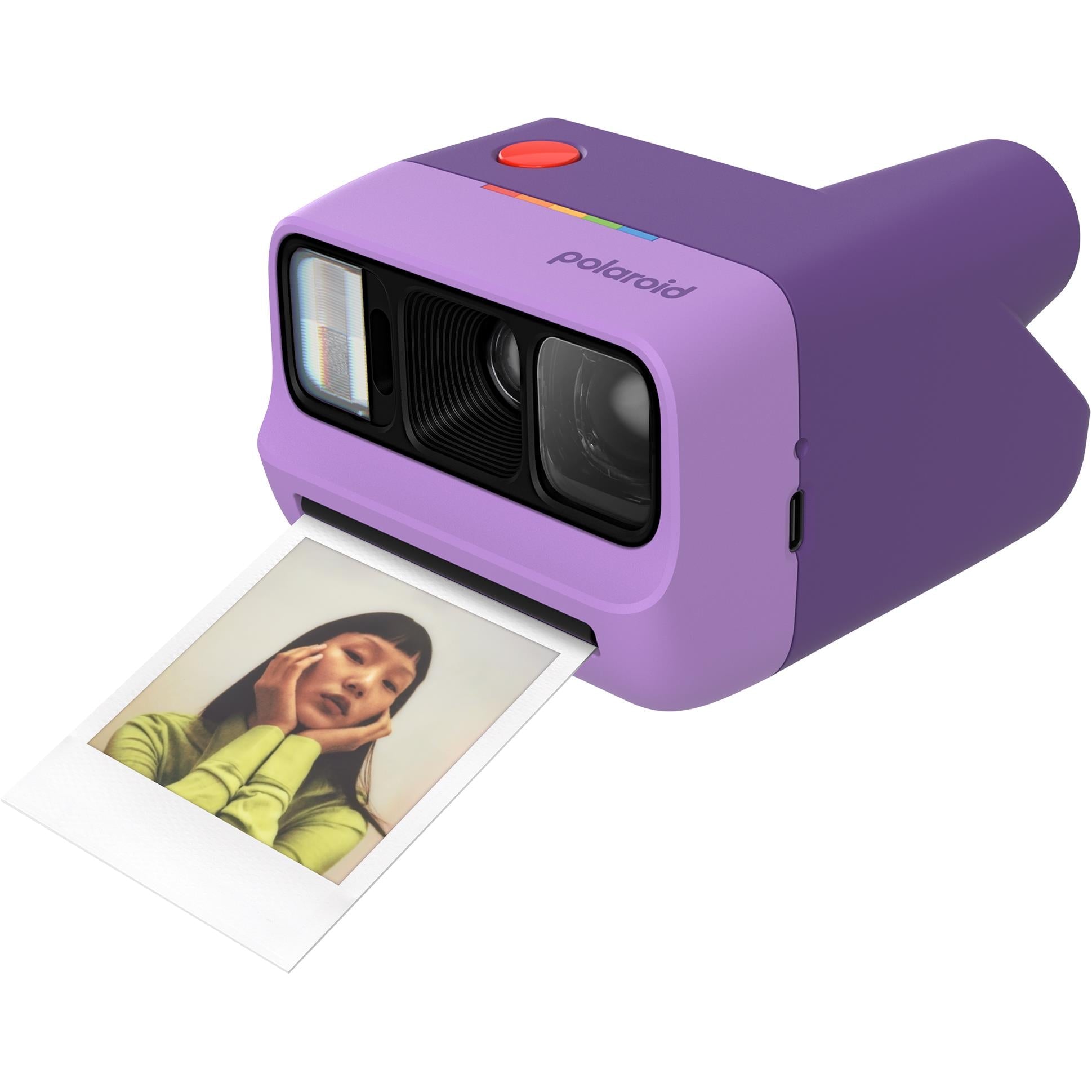 Purple Polaroid Go Generation 3 pocket instant camera printing a photo on the tray