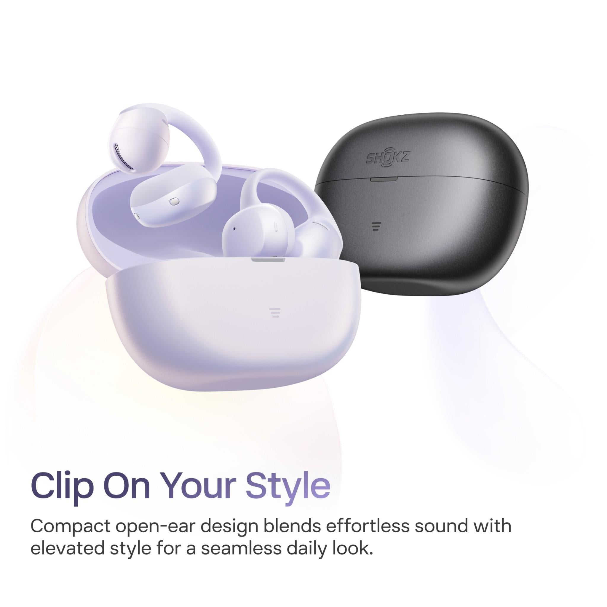 Daybreak Purple open-ear earbuds on open charging case beside a dark case