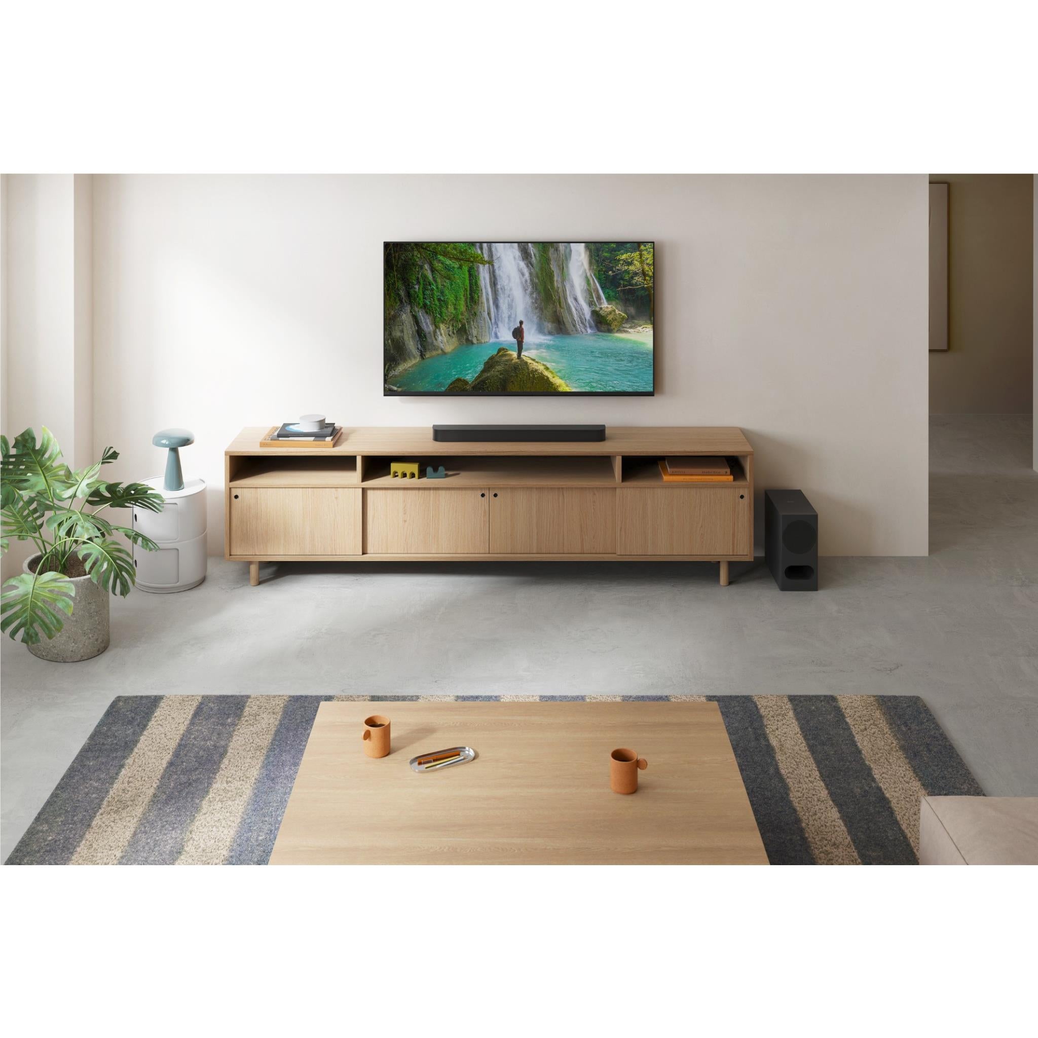 3.1ch Atmos soundbar on media console with TV and black subwoofer