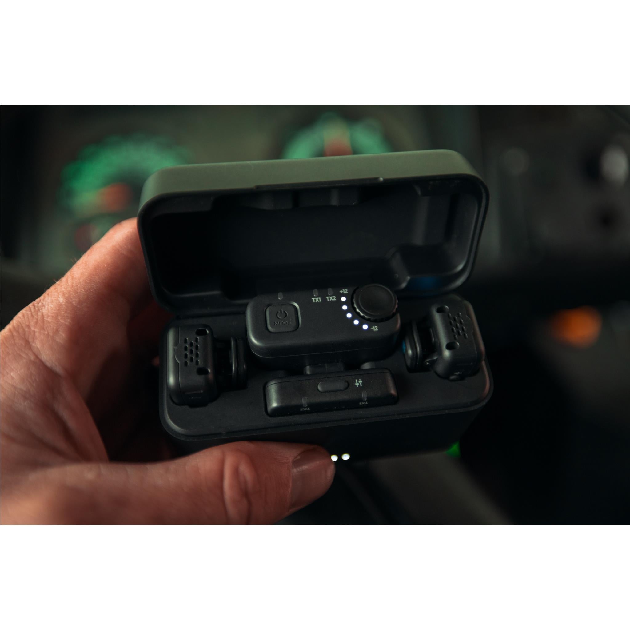 GoPro wireless microphone kit case open in hand showing receiver and transmitters