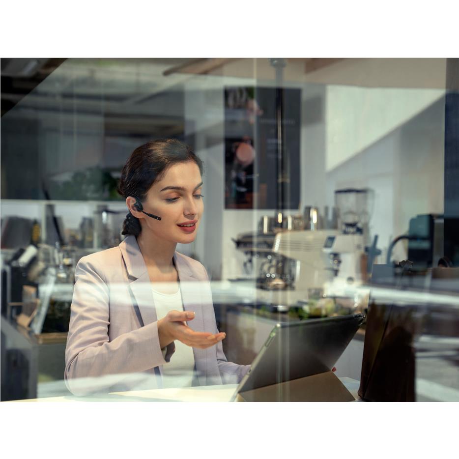 Black open-ear bone conduction headset worn with boom mic for office communication