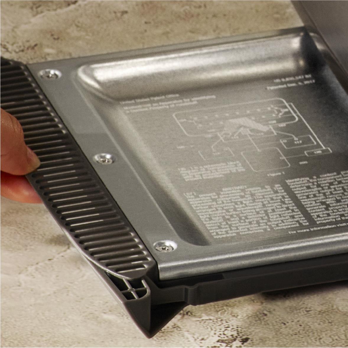 Opened crumb tray and black toaster base with metal interior panel