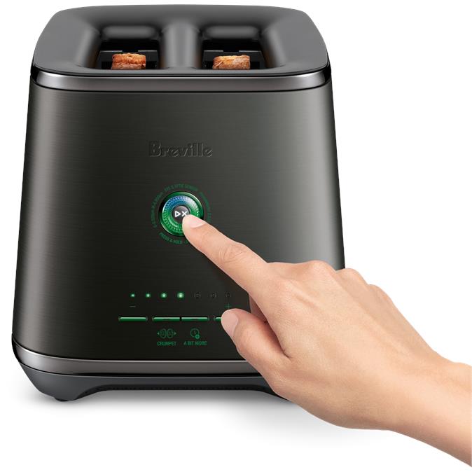 2-slice black toaster with hand touching the temperature dial and two slots