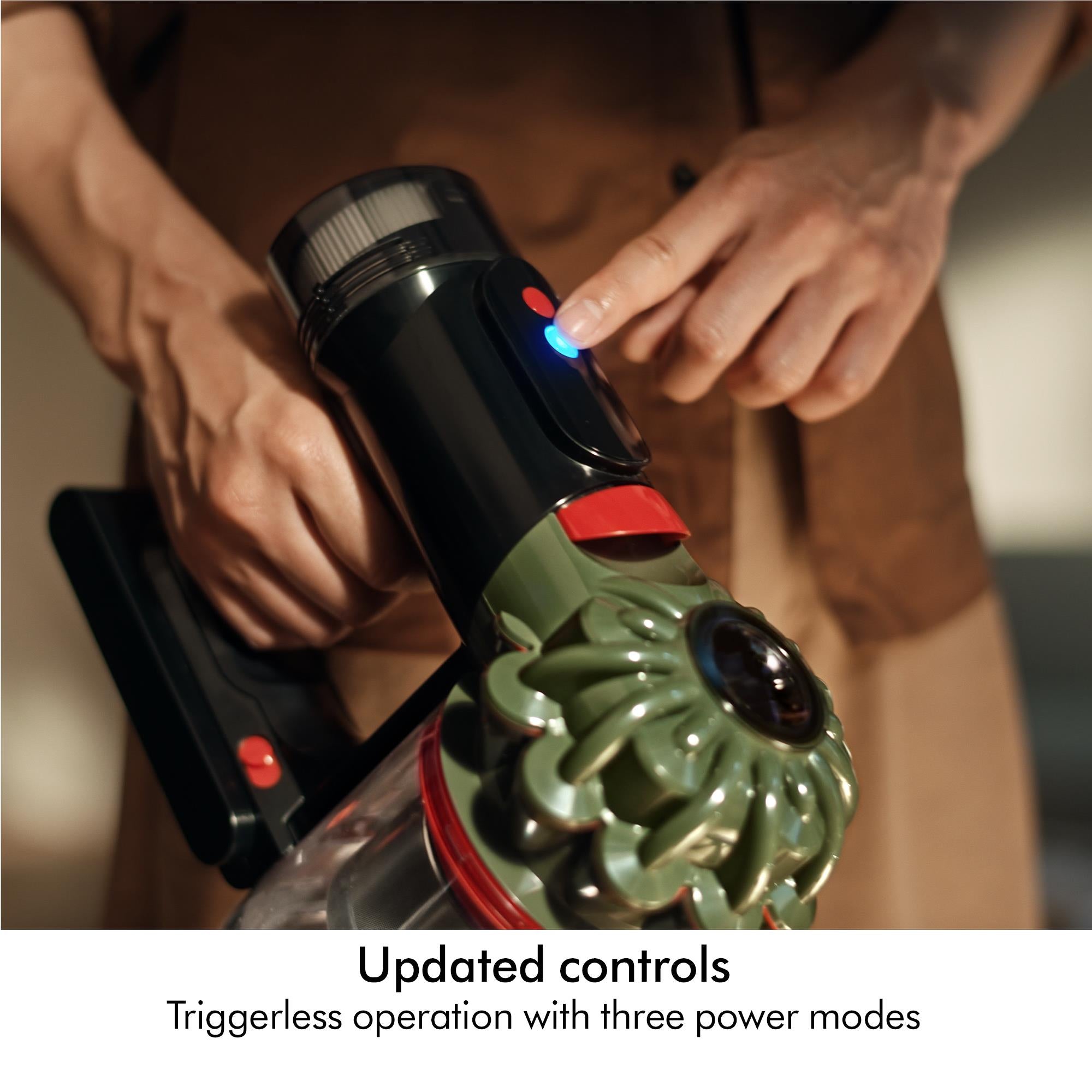Dyson cordless vacuum cleaner with green cyclone head and red trigger control