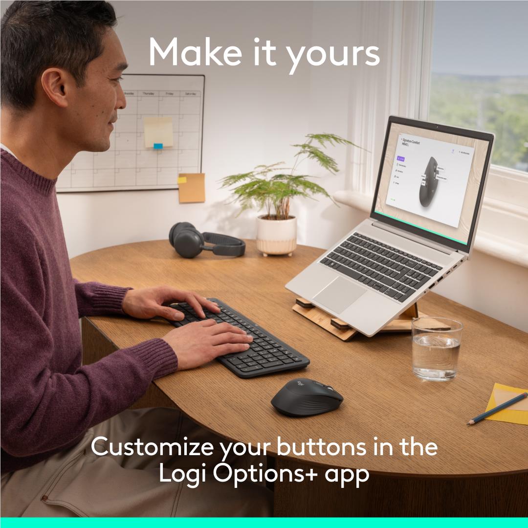 Person using Logitech graphite quiet-click mouse on an office desk