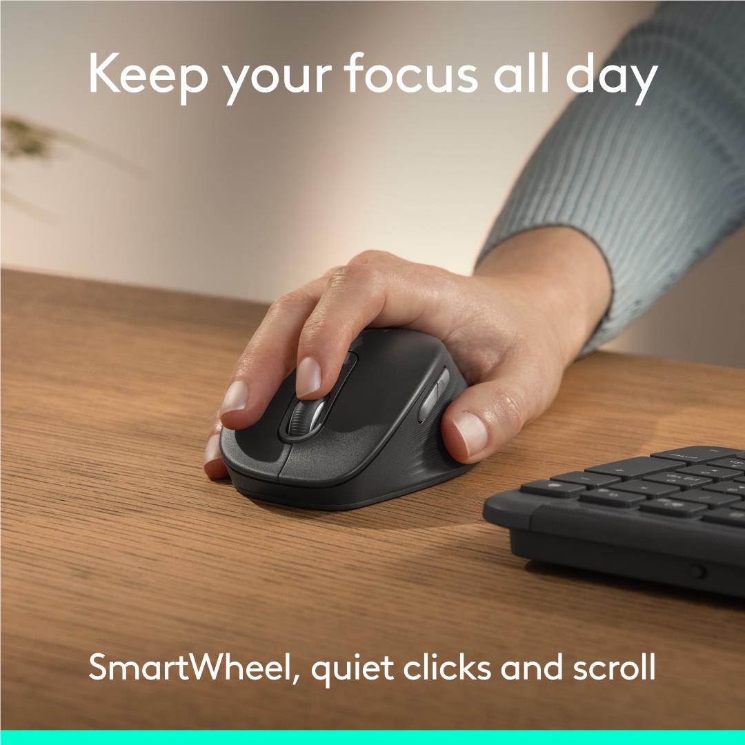 Hand gripping Logitech graphite quiet-click mouse with curved front contour