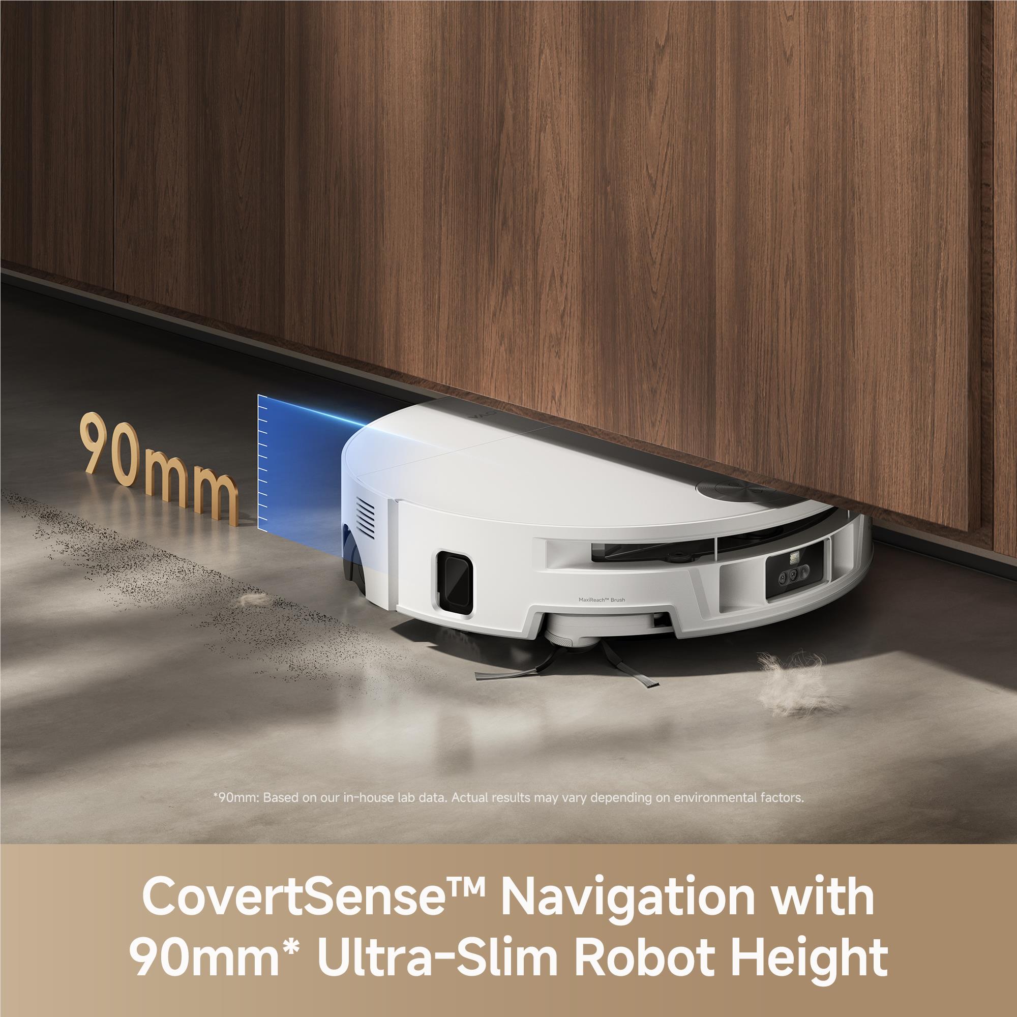 White wet and dry robot vacuum in a narrow gap under kitchen cabinets