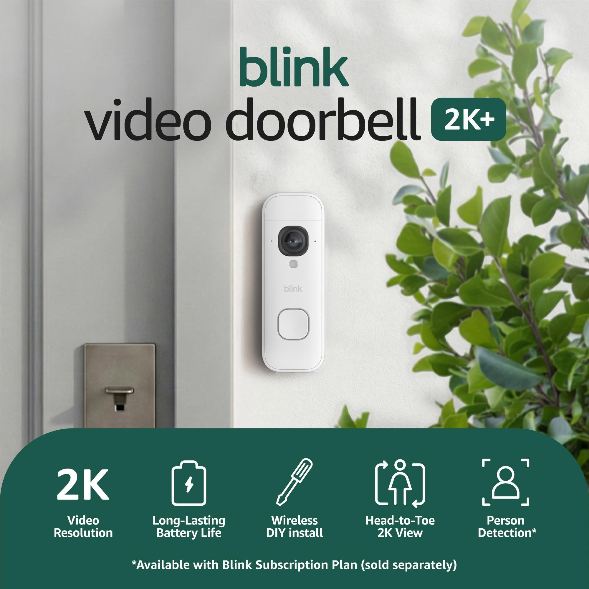 White wireless video doorbell mounted outdoors on a wall, with camera and button