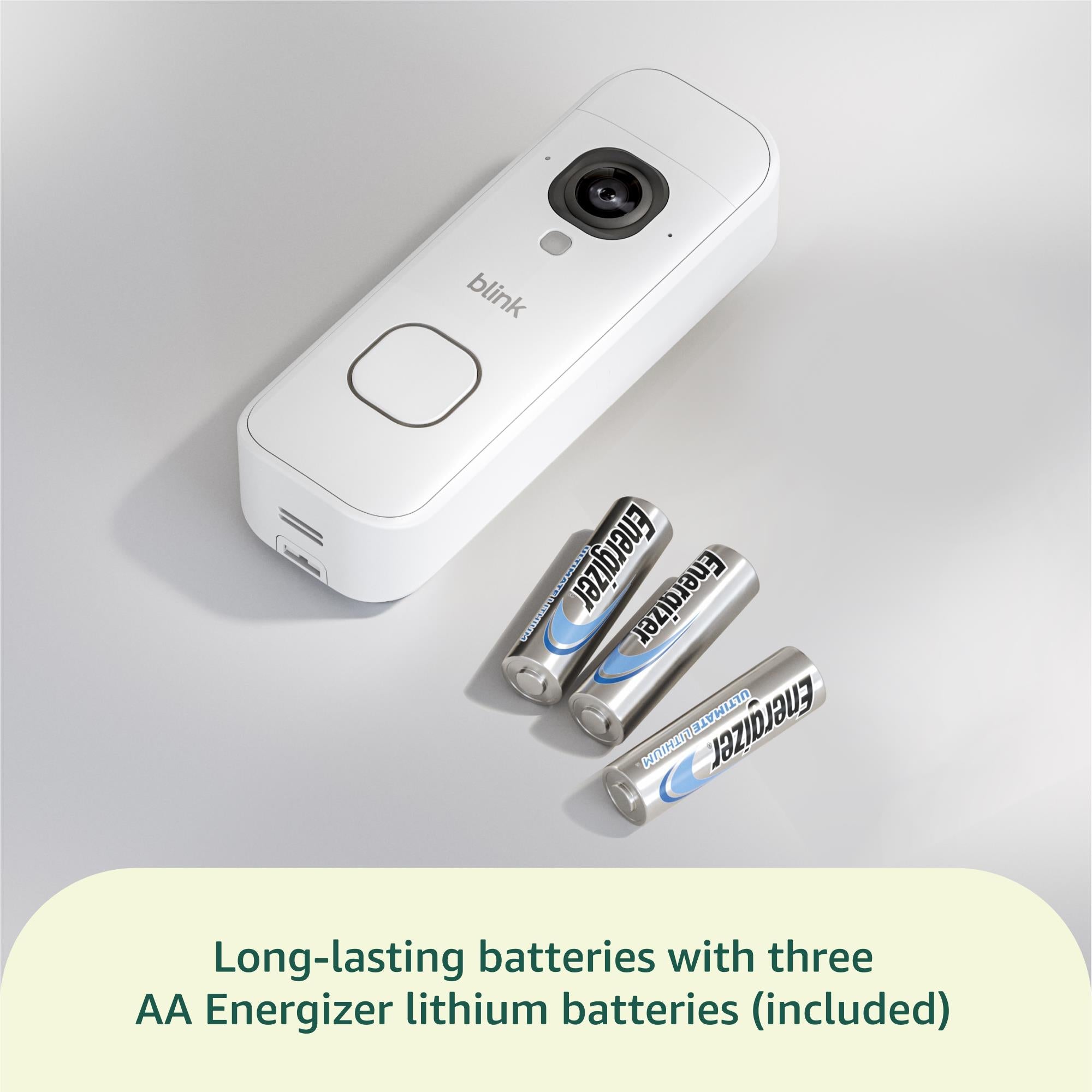 White video doorbell with camera and battery compartment, plus included AA batteries