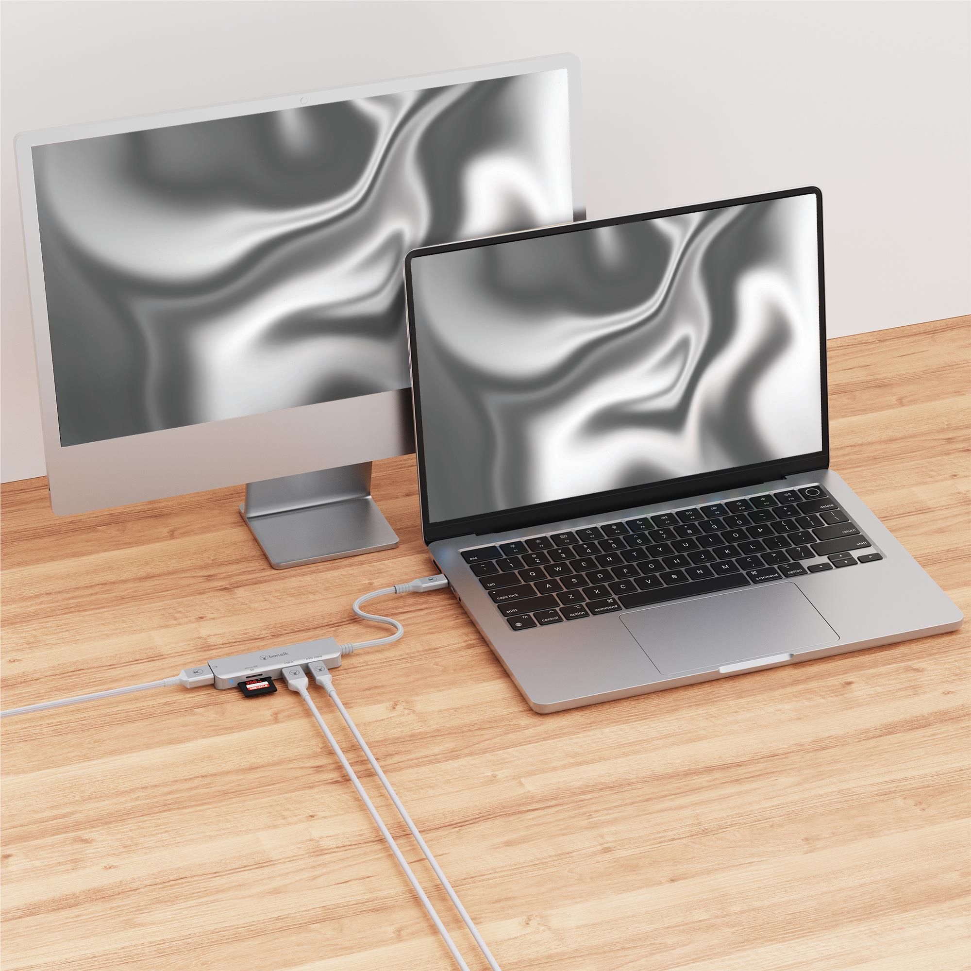 Silver grey USB-C 5-in-1 multiport hub connected to laptop and display