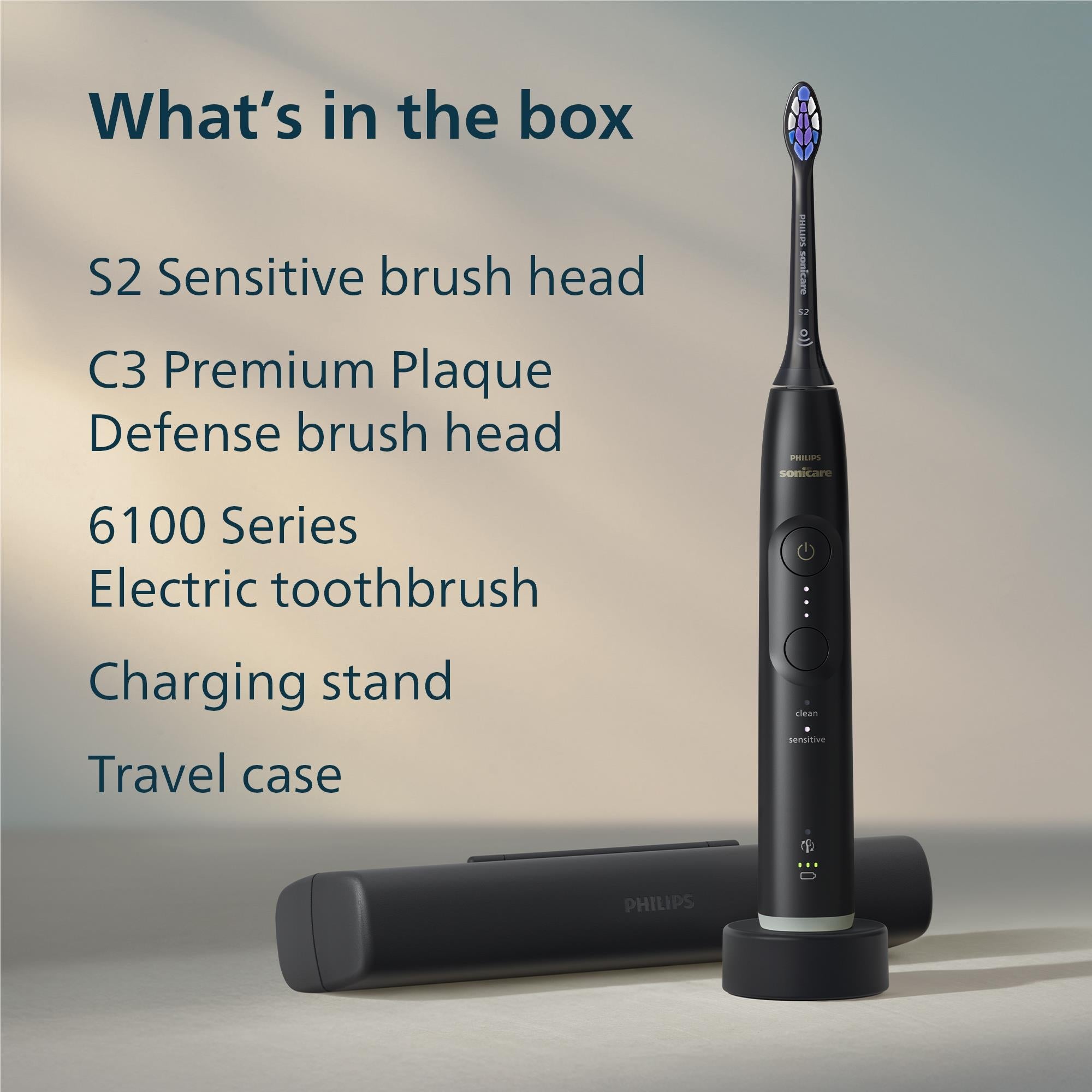 Black electric toothbrush with base charging stand and included brush heads