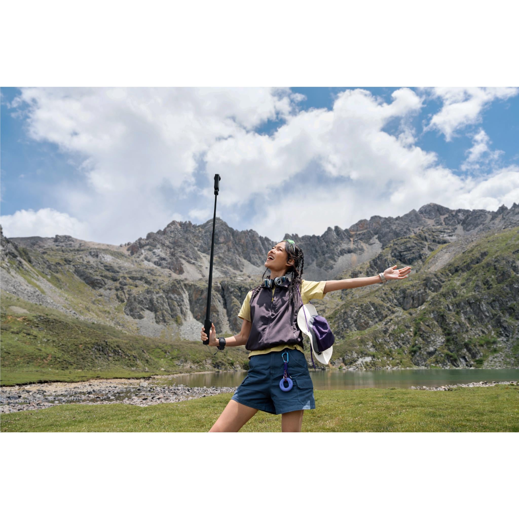 360 action camera on extendable selfie stick, black, with compact mounting arm