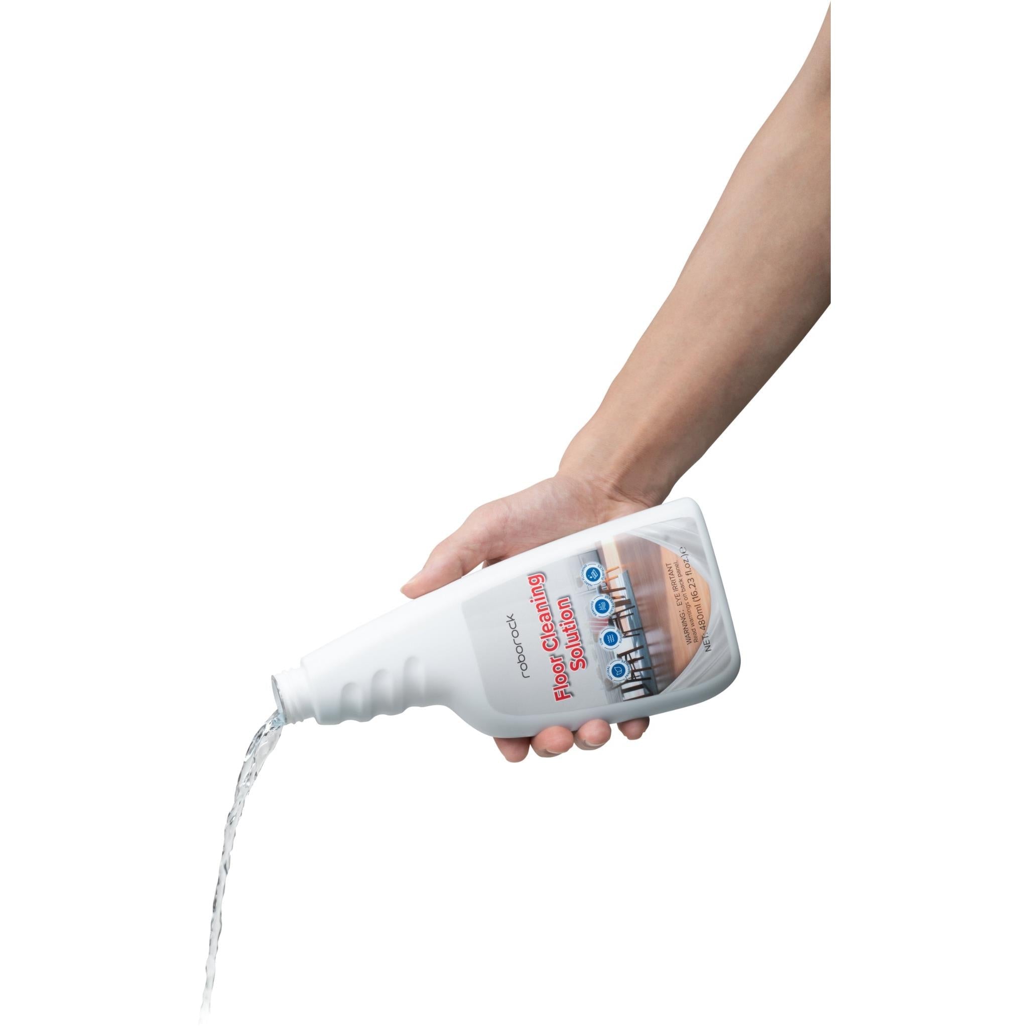 Roborock floor cleaning solution bottle pouring liquid, held in hand