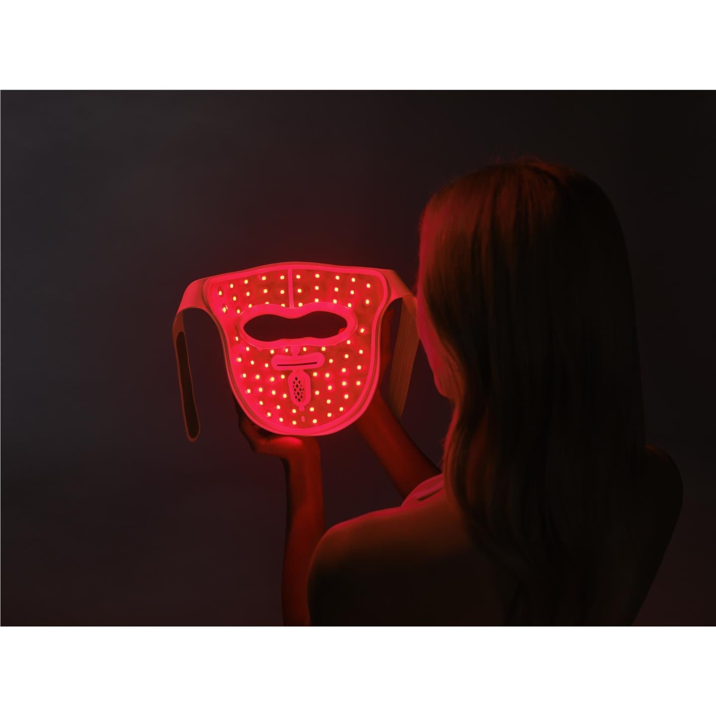 LED face mask glowing red on a person’s face