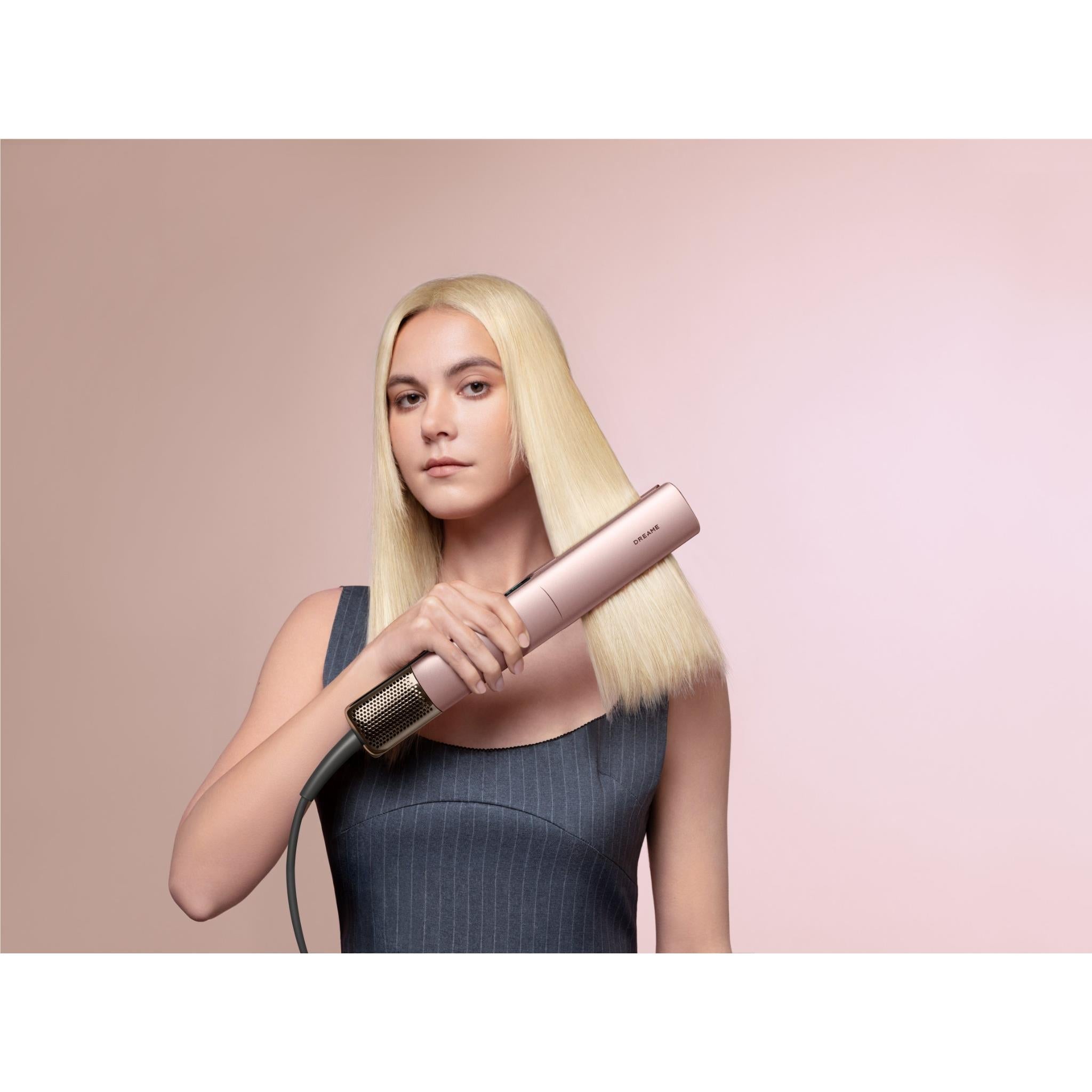 Rose-gold 2-in-1 hair dryer and straightener in use on blonde hair