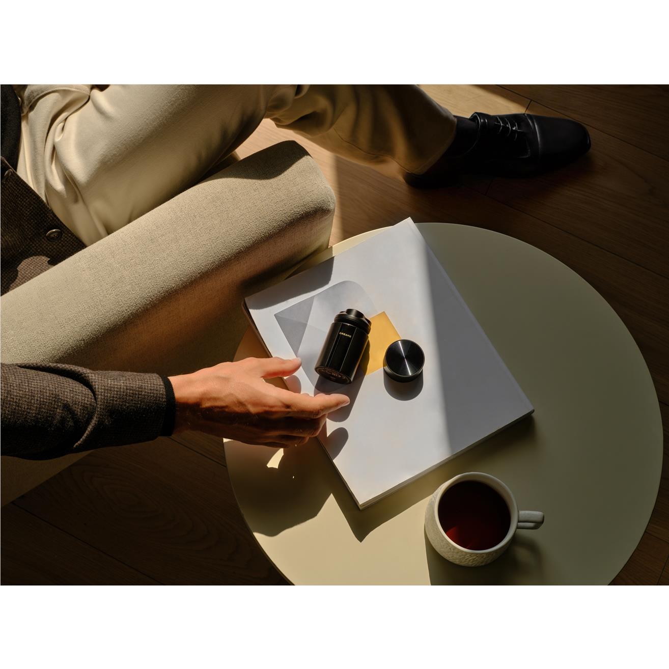 Black electric beard shaver and accessories in packaging on a table