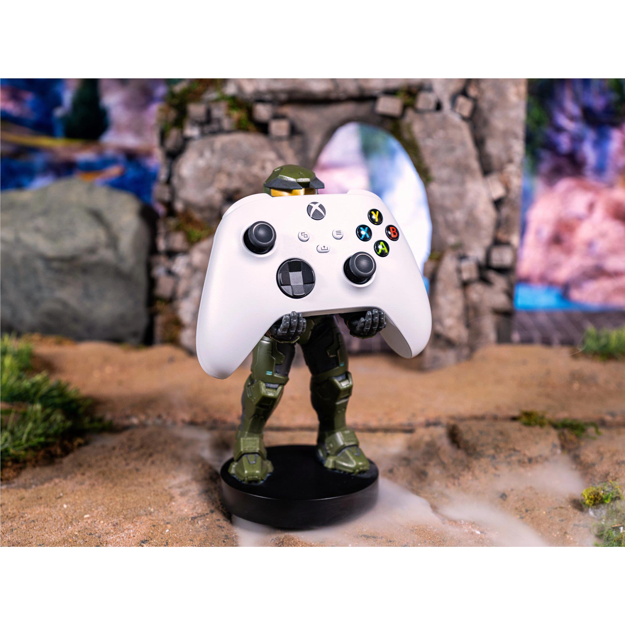 Green armored figure phone stand with white game controller topper, black round base