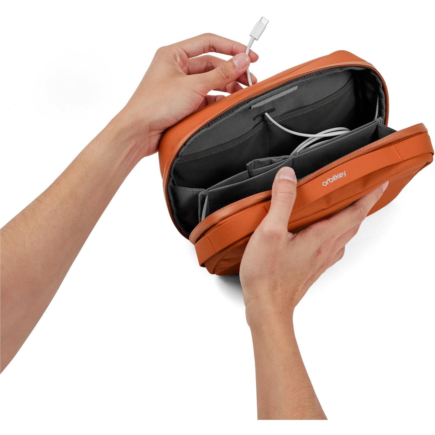 Orbitkey tech pouch with internal dividers, held open for cables and accessories