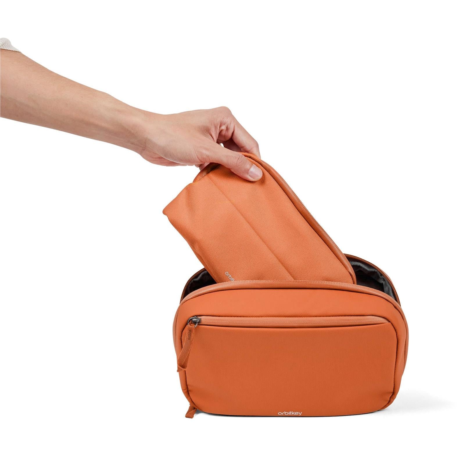 Orbitkey tech pouch with front zipper, compact rectangular shape, terracotta exterior