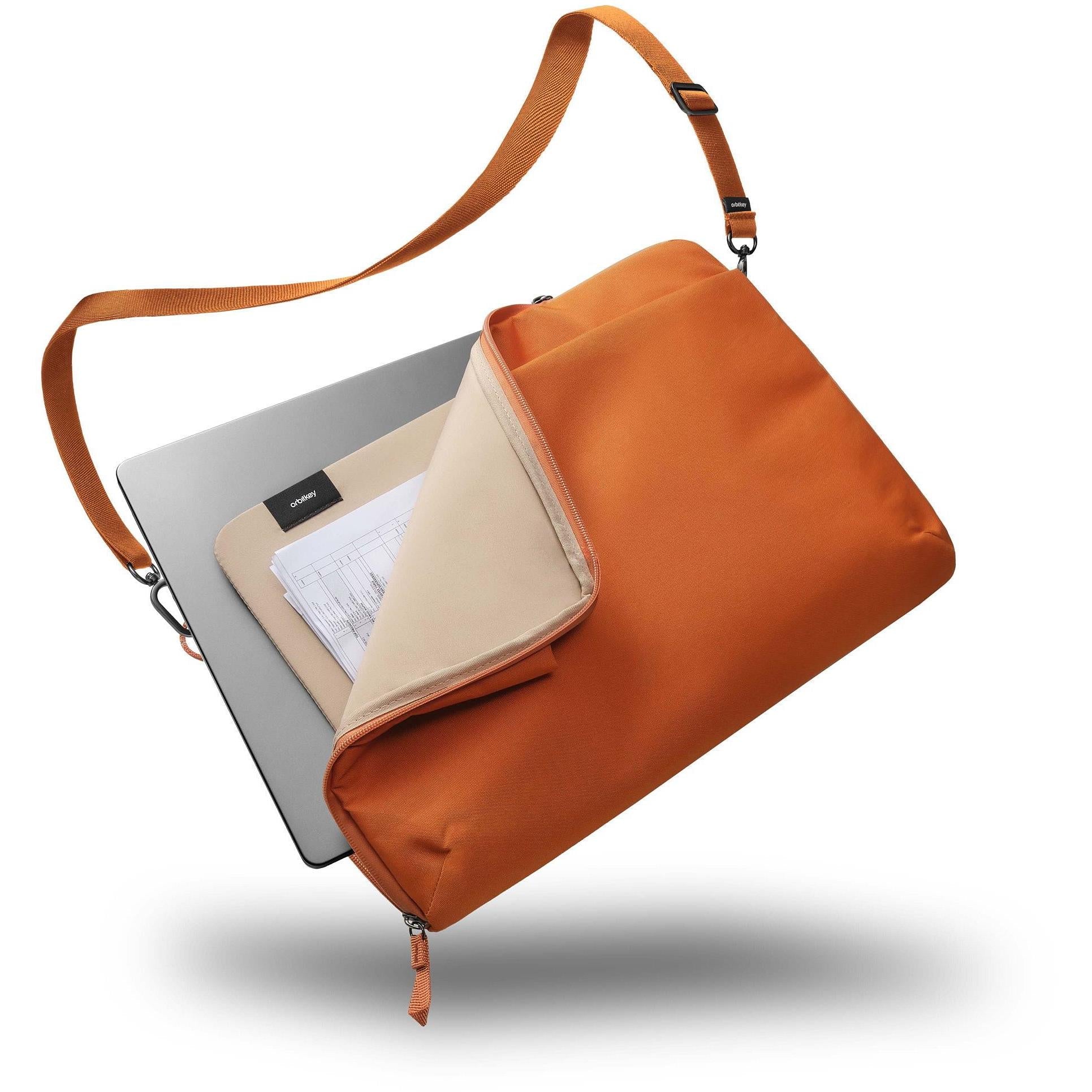 Terracotta laptop sleeve with open zip top and integrated shoulder strap