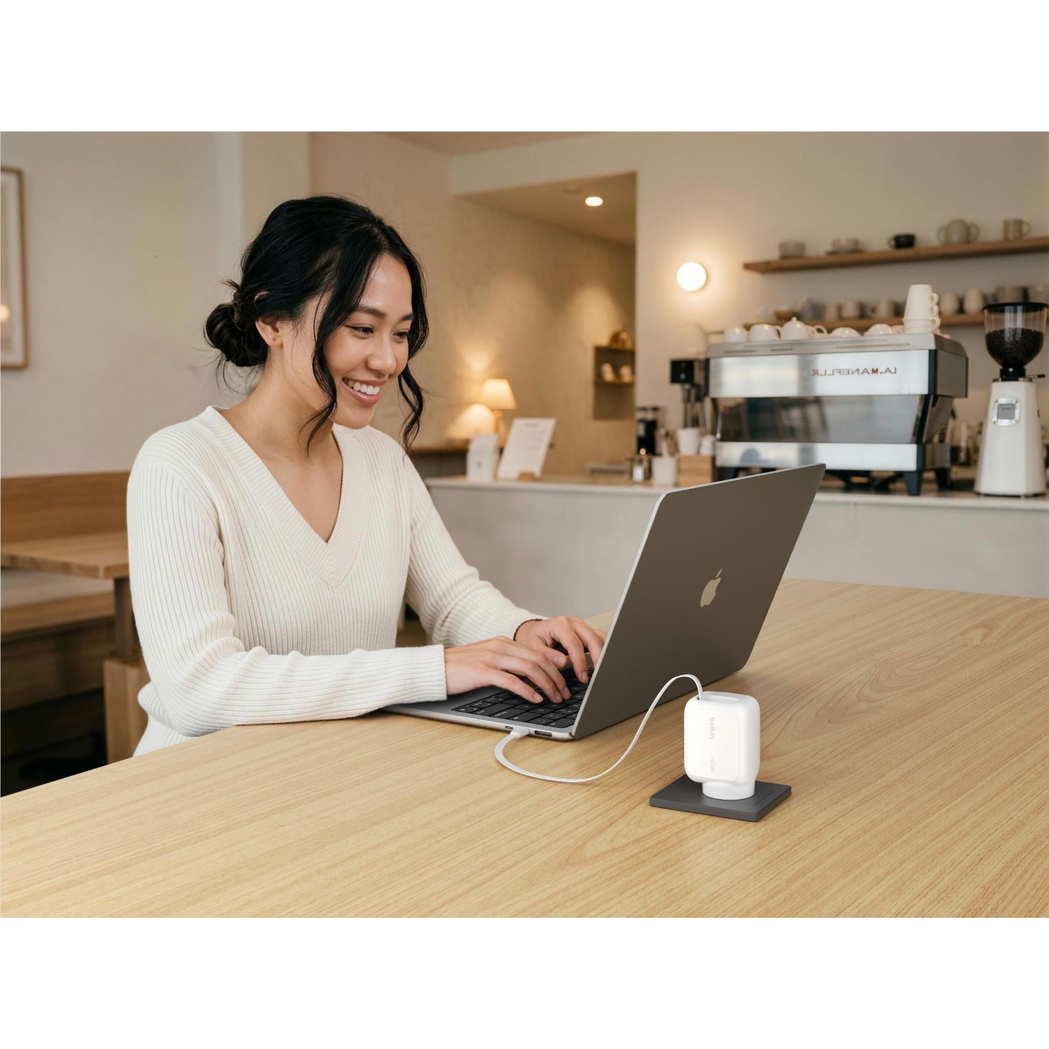 White wall charger mounted on wall, USB-C cable powering a laptop