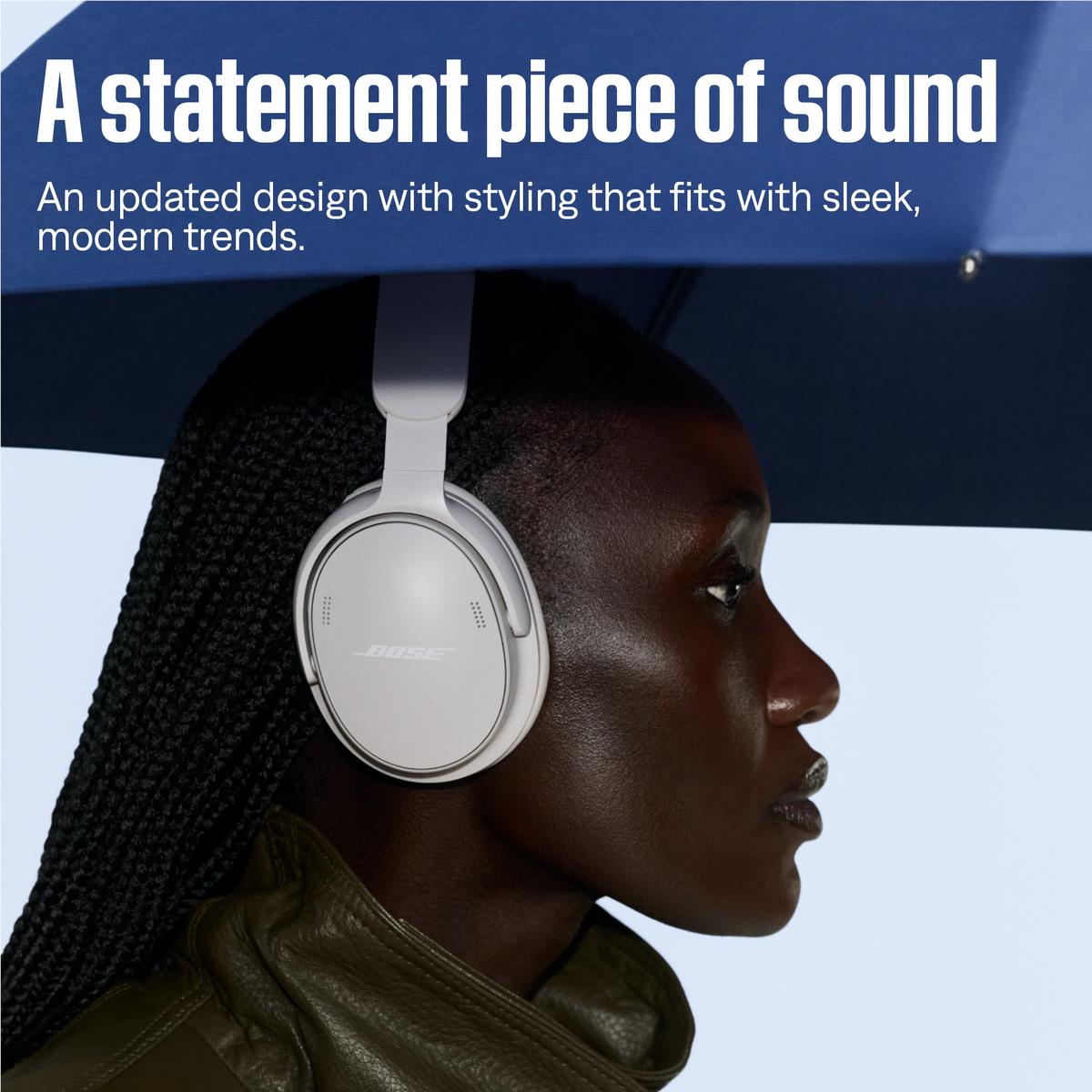 White over-ear headphones with green ear cushions worn on a person