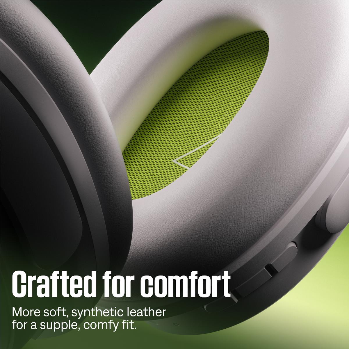 Close-up of white over-ear headphones showing green ear cushion mesh