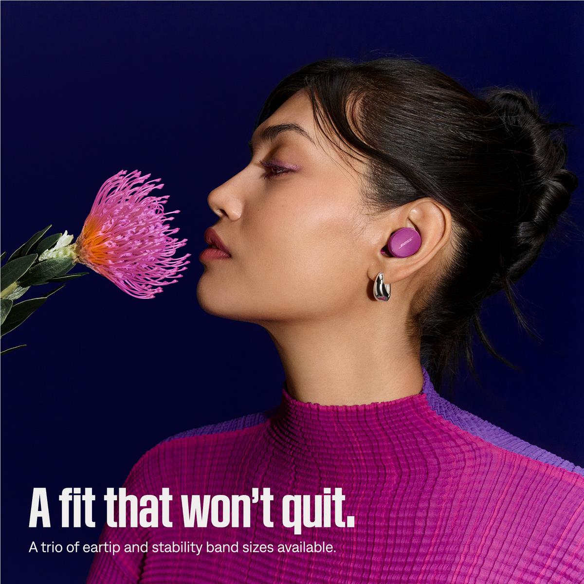 Rosewood mauve in-ear earbuds on model ear, Bose wireless earbuds