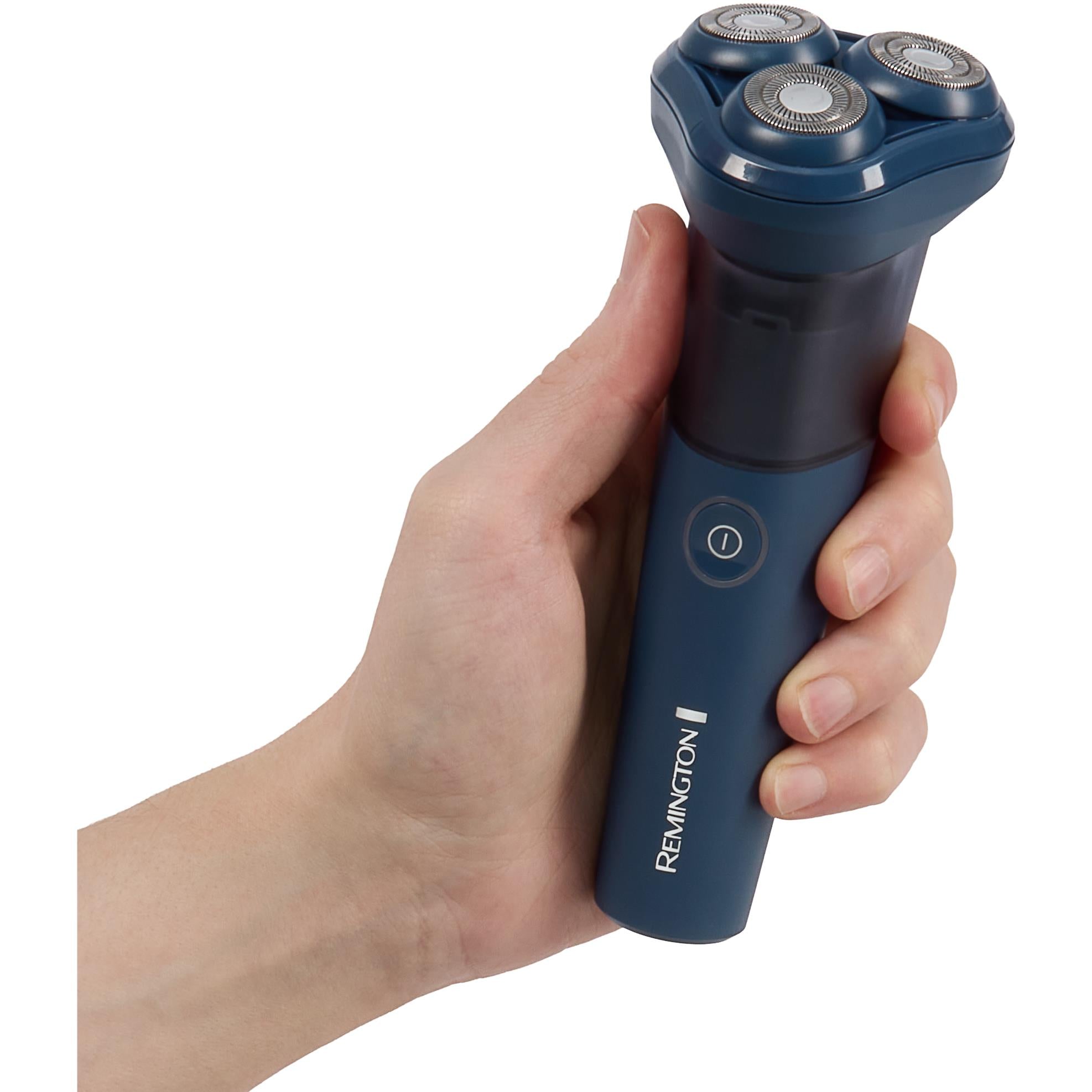 Hand holding blue Remington rotary shaver with three heads and power button