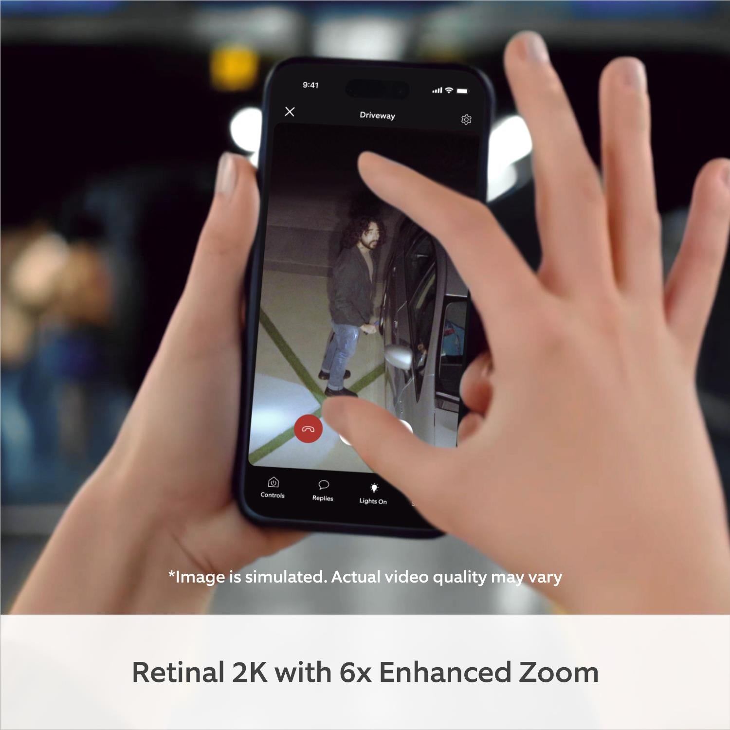Smartphone showing live view from a white outdoor floodlight camera app