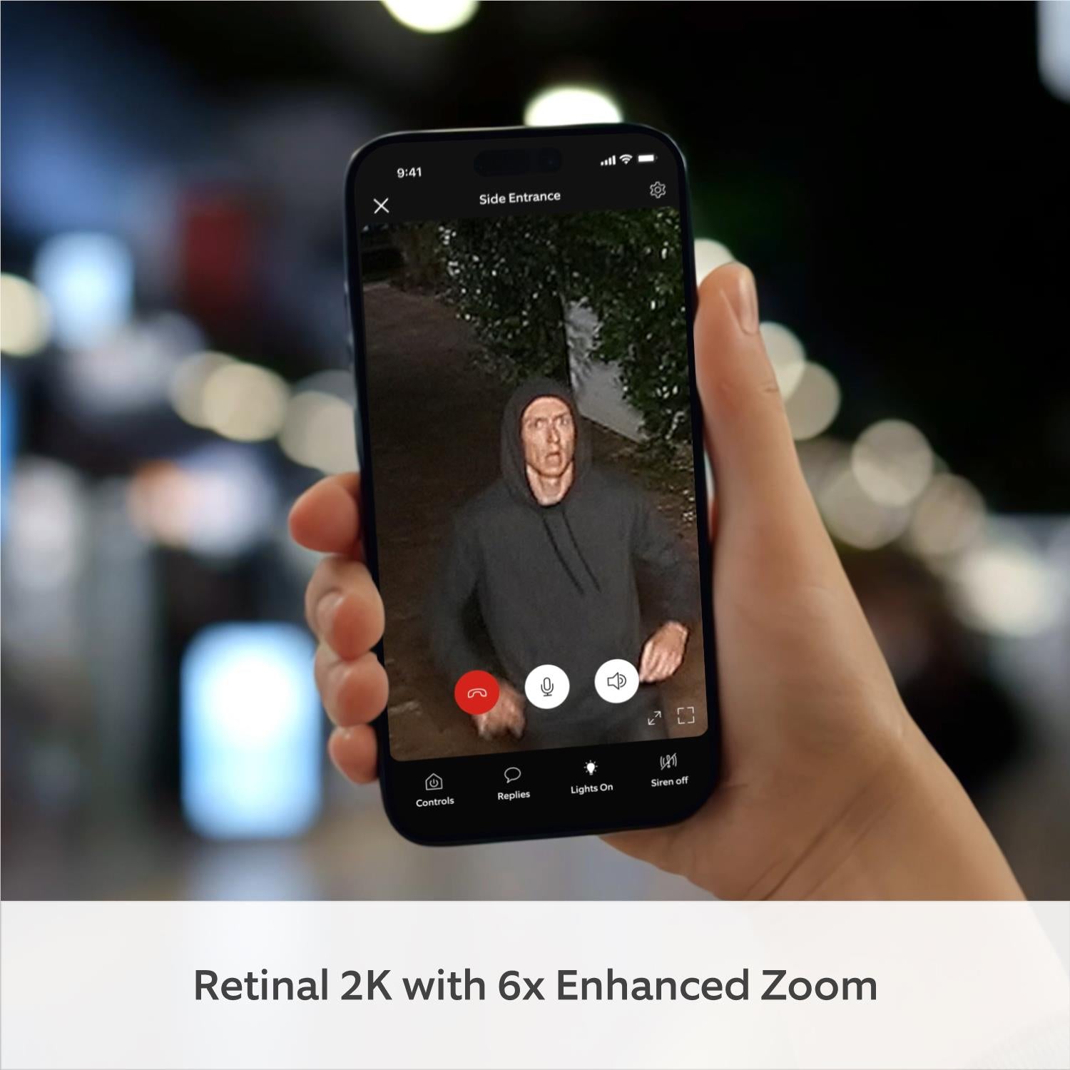 Smartphone in hand showing ring camera live view with talk controls