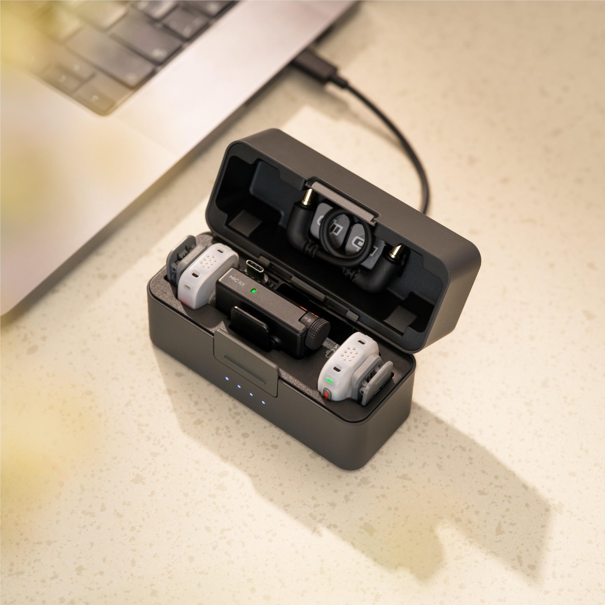 DJI wireless microphone kit opened in case showing transmitters, receiver, and cables