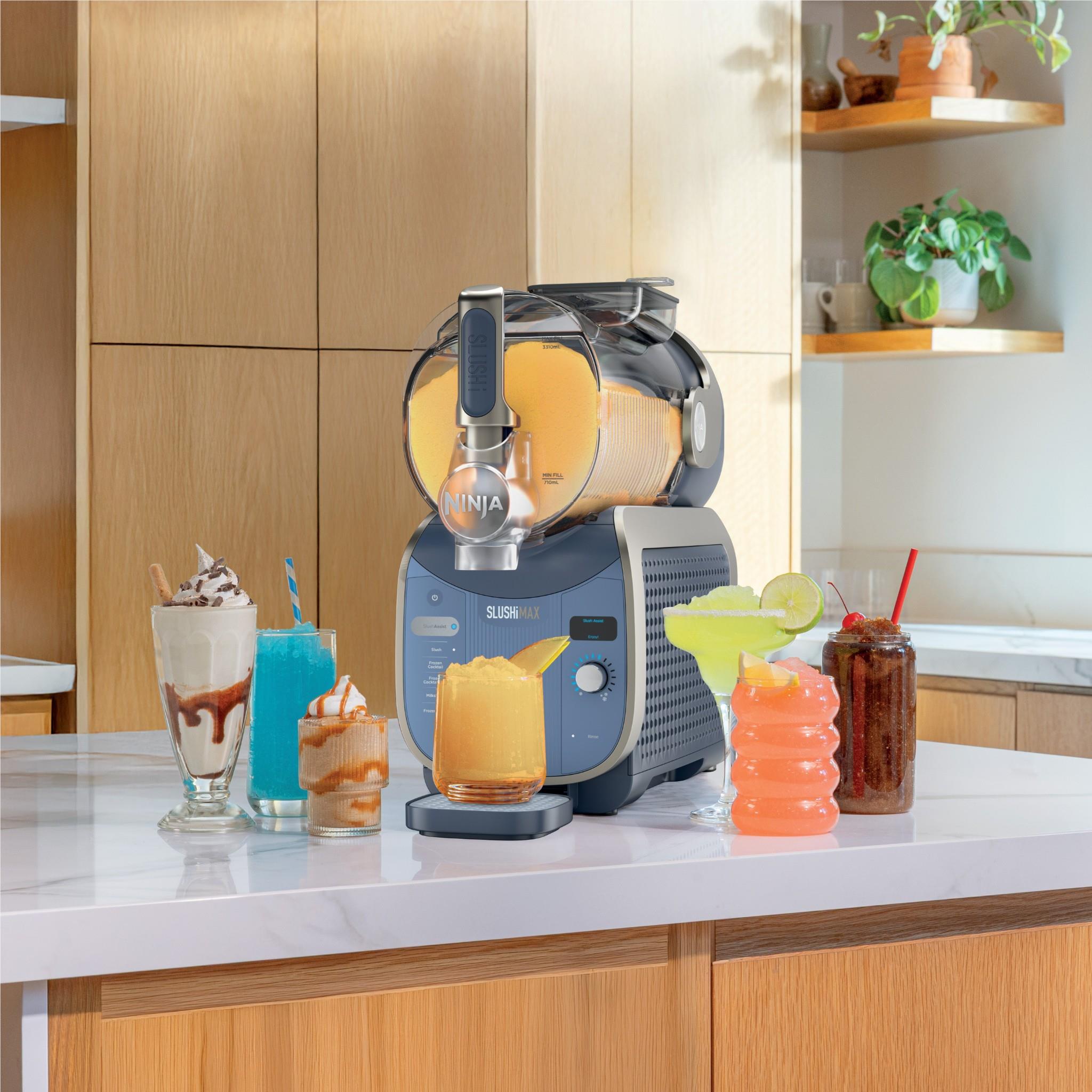 Blue frozen drink maker making yellow and orange slush cups on countertop