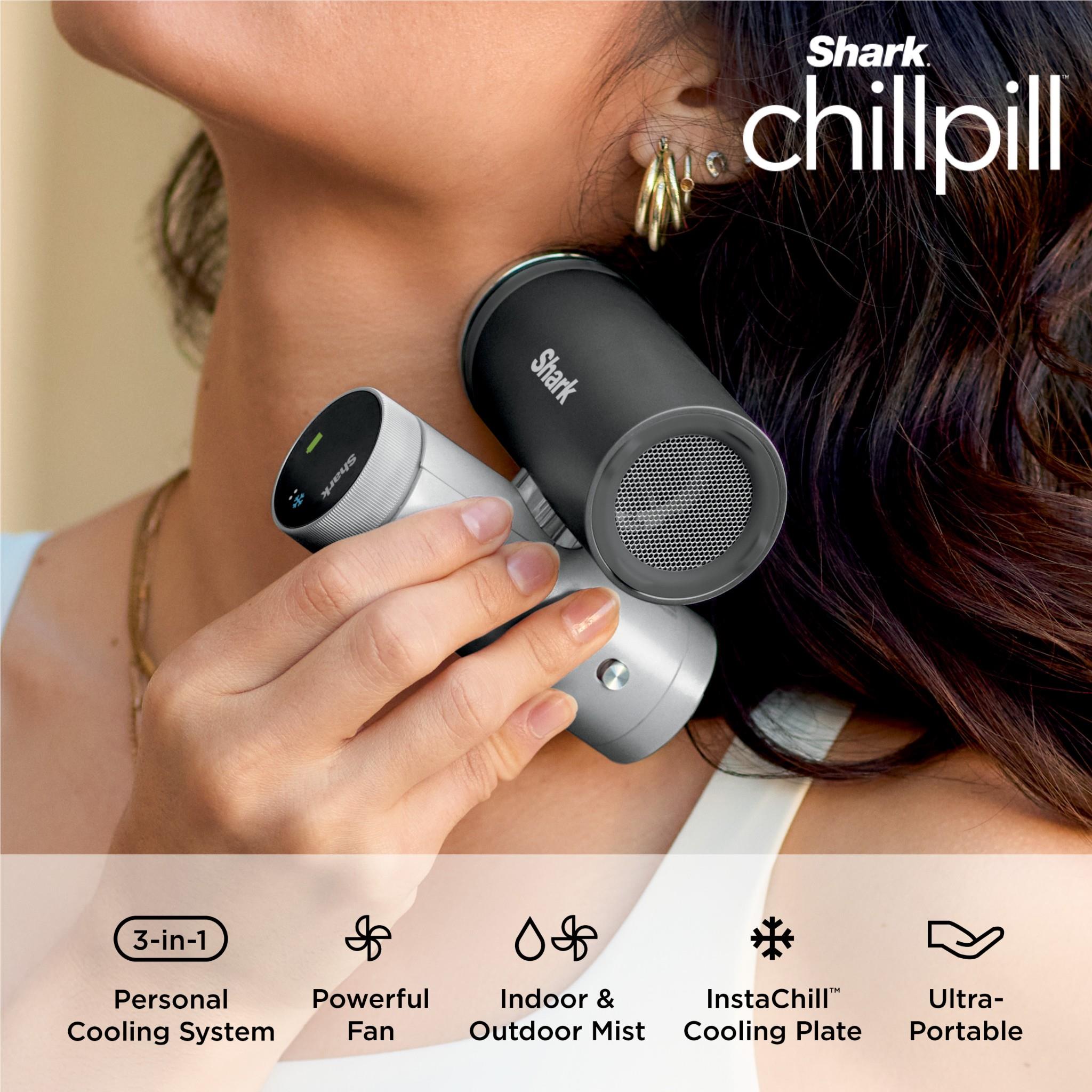 Charcoal handheld cooling fan held near neck with silver faceplate