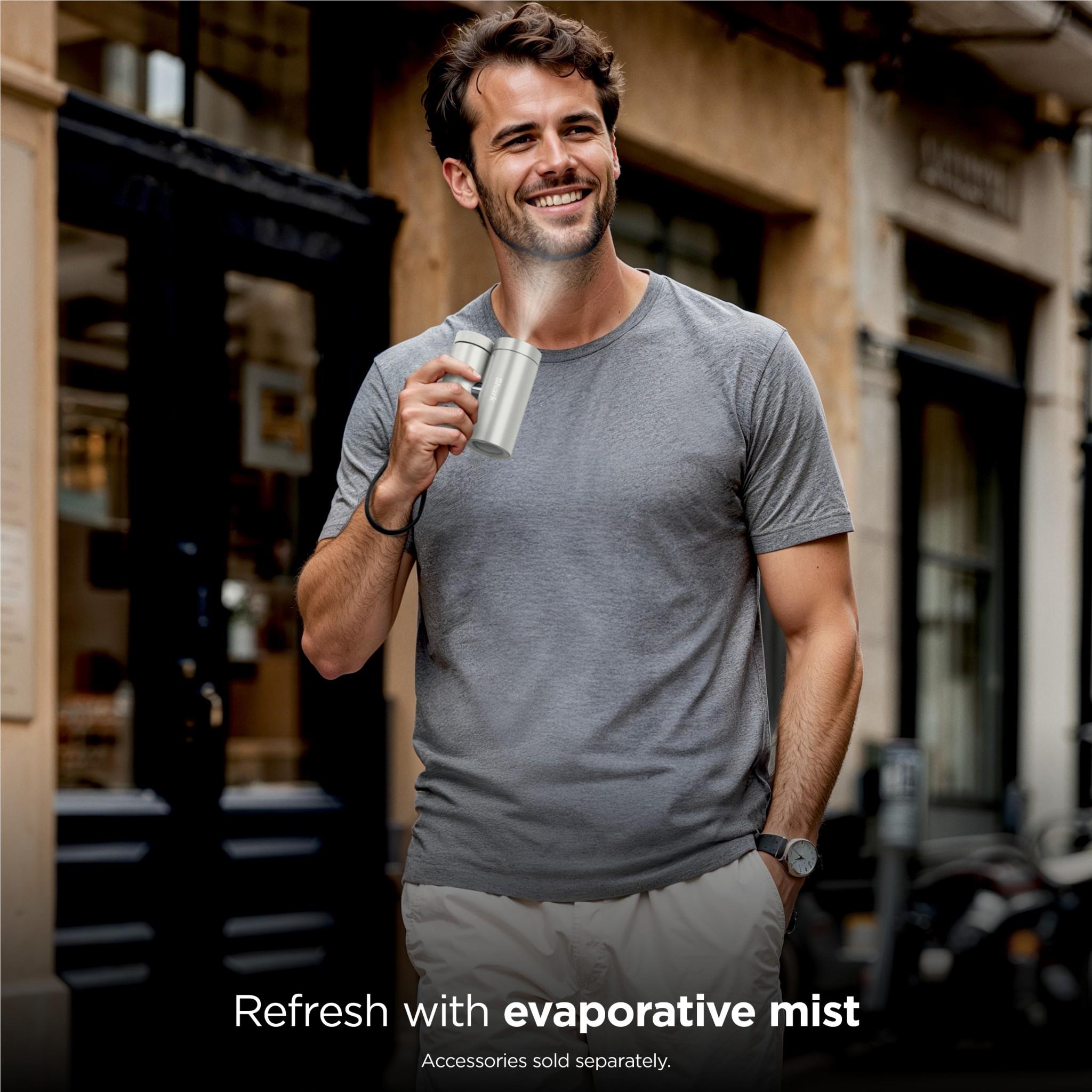 White Shark ChillPill personal cooling fan and mist held in hand during evaporative cooling