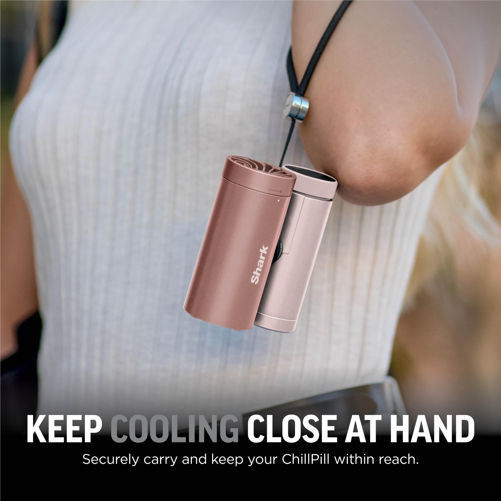 Rose gold handheld fan and mister held in hand with compact cylinder body