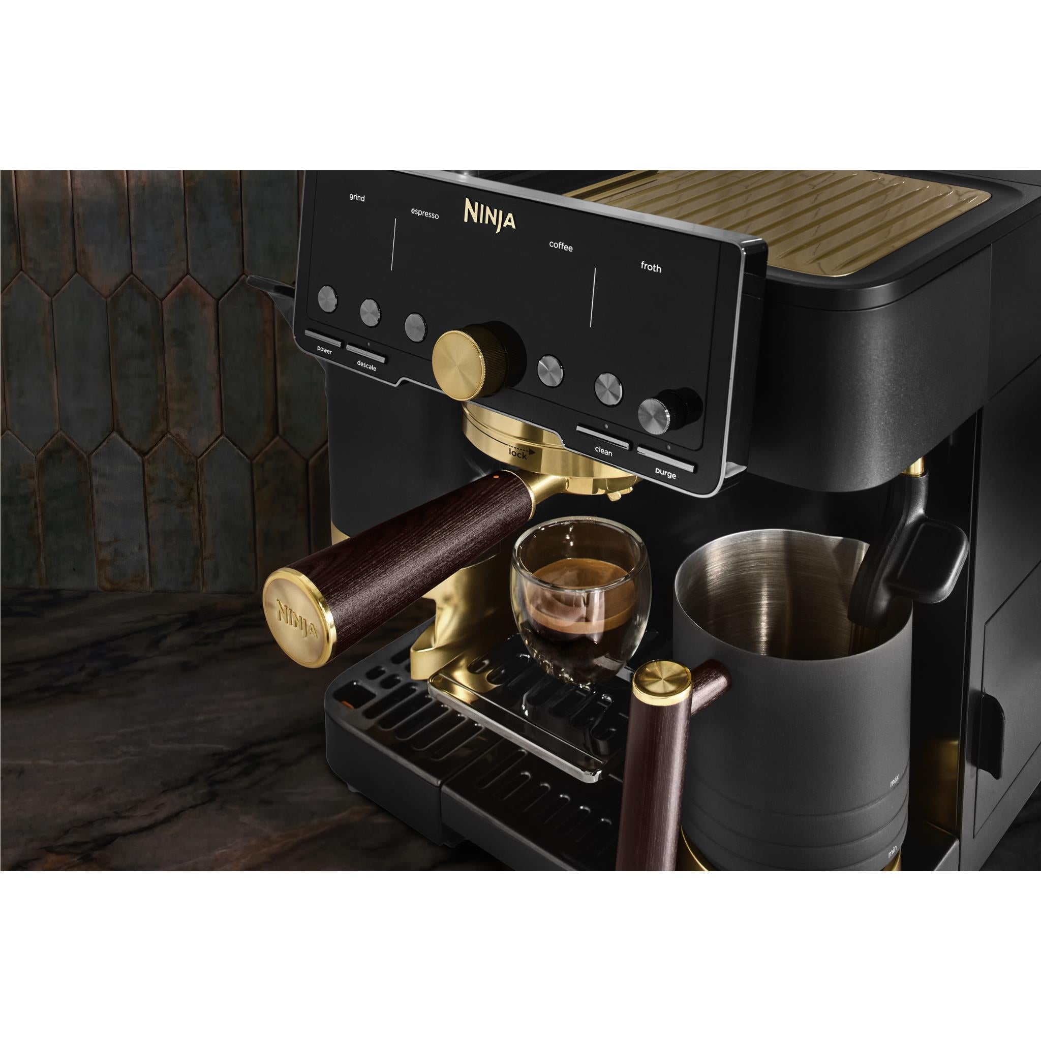 Ninja espresso machine steam wand with dark wood handle and cup on drip tray
