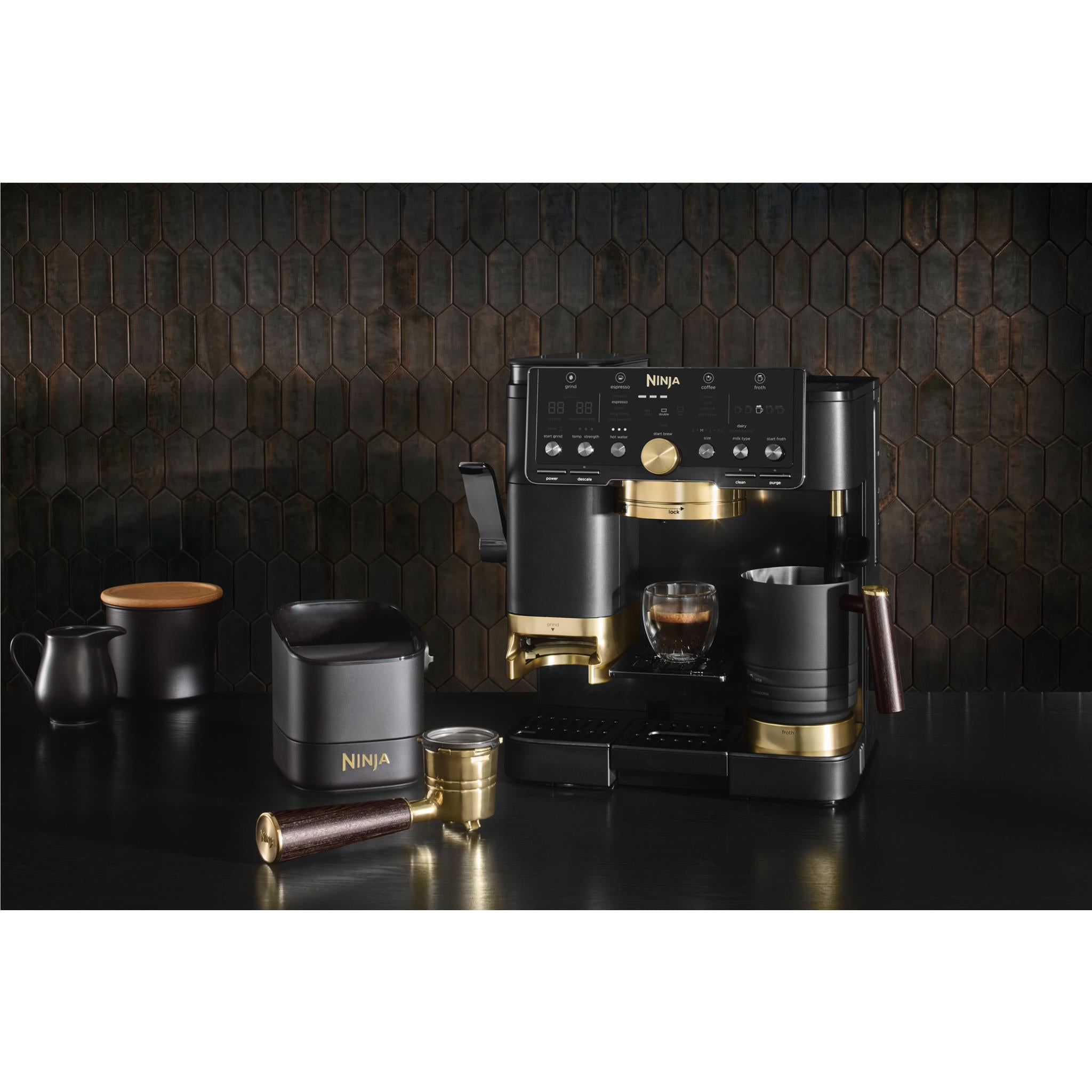 Black Ninja espresso machine with gold trim, cups, and accessory set