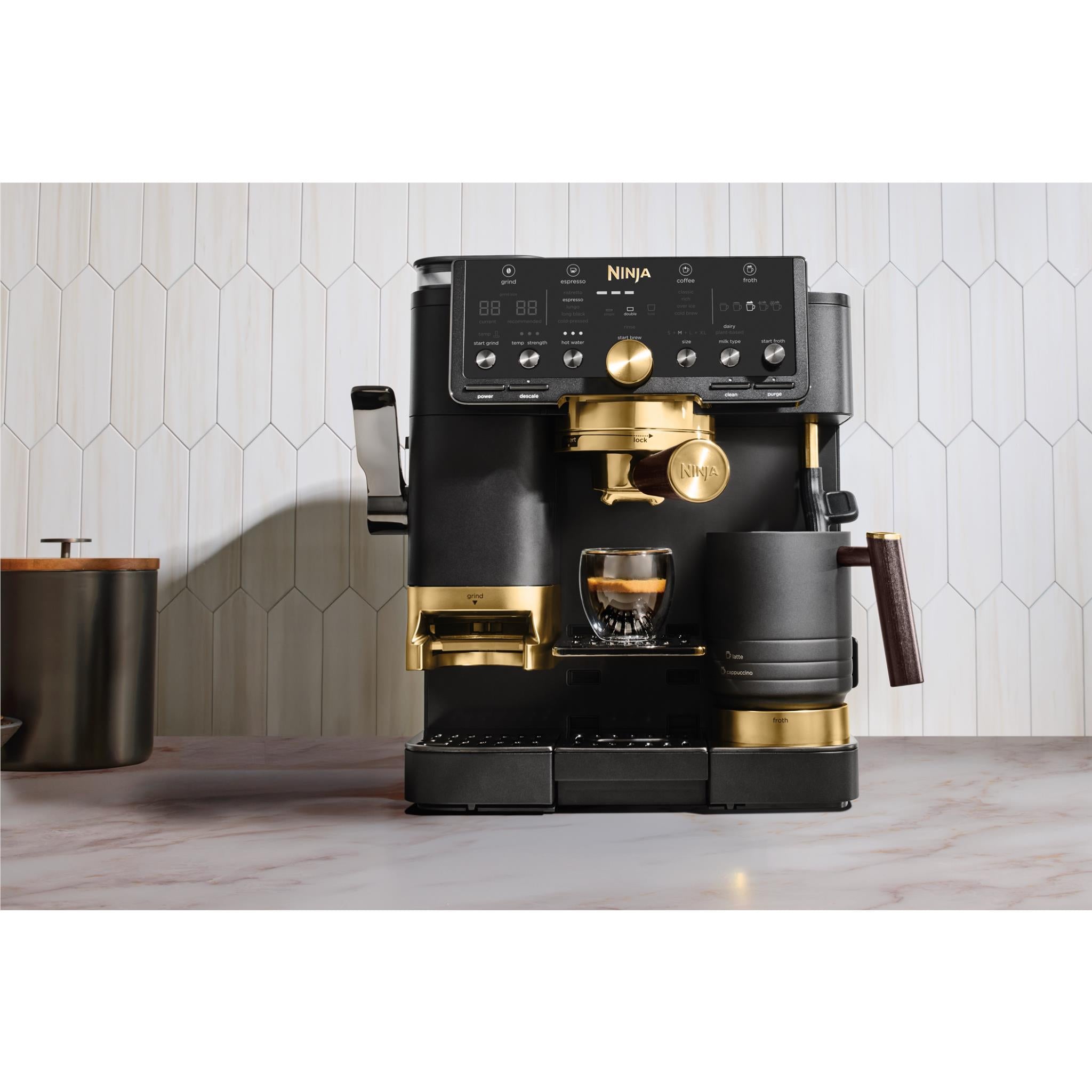 Front view of Ninja 3-in-1 espresso machine in black with gold accents and cups