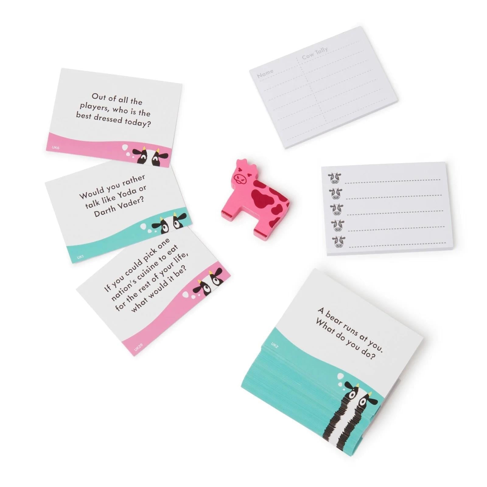 Question prompt cards with teal and pink panels plus pink cow token