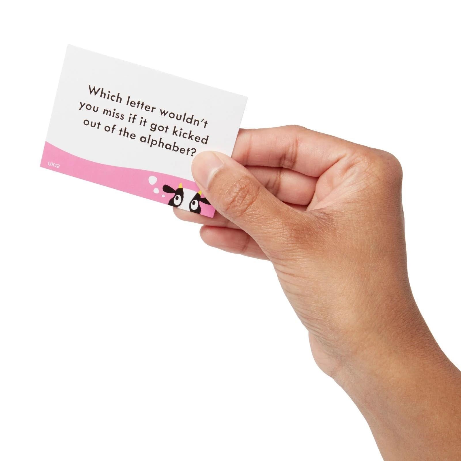 Hand holding a question prompt card with pink and teal design